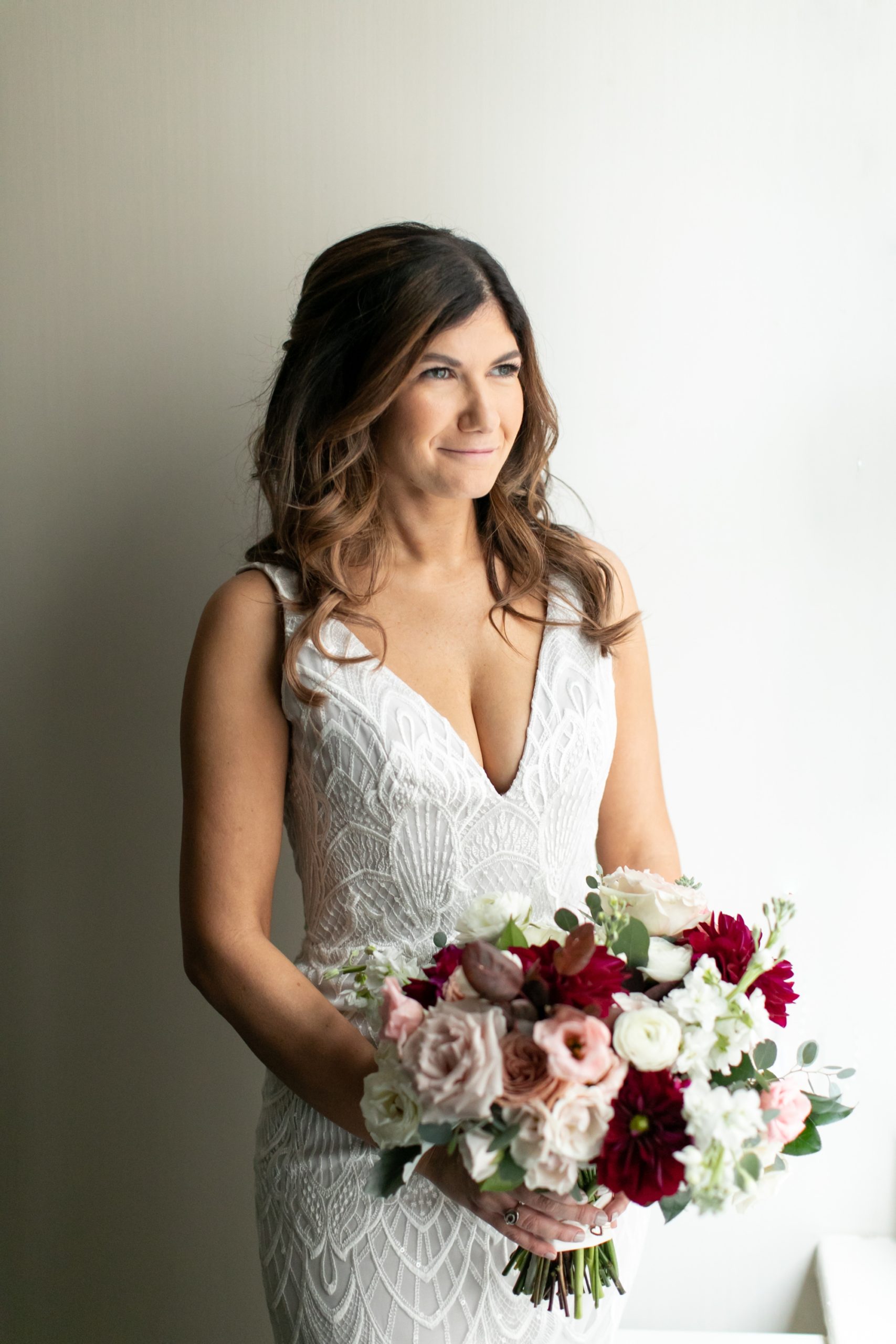 the bride wore a lace wedding dress and carried a large bridal bouquet