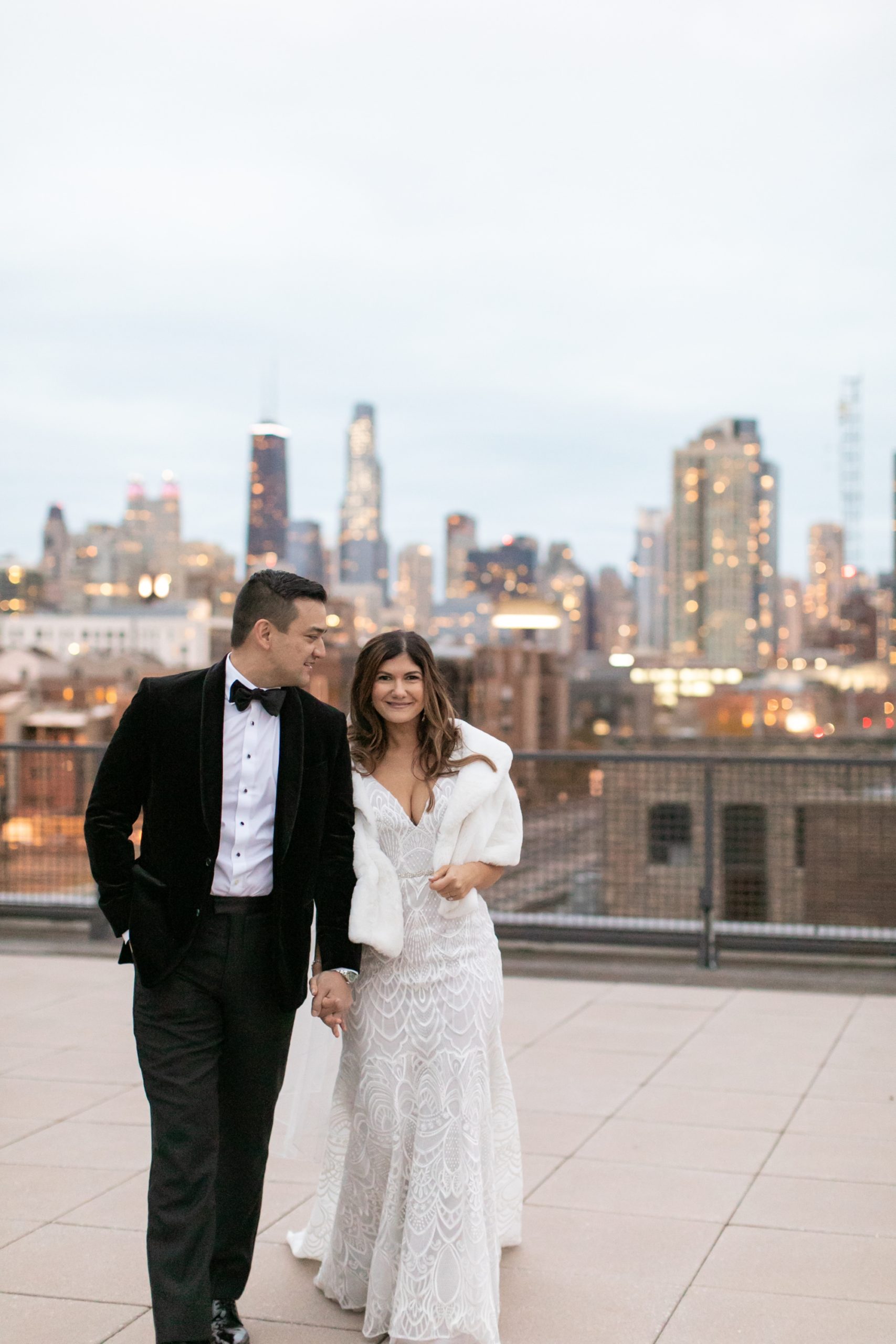 the bride and groom posed for rooftop wedding photos