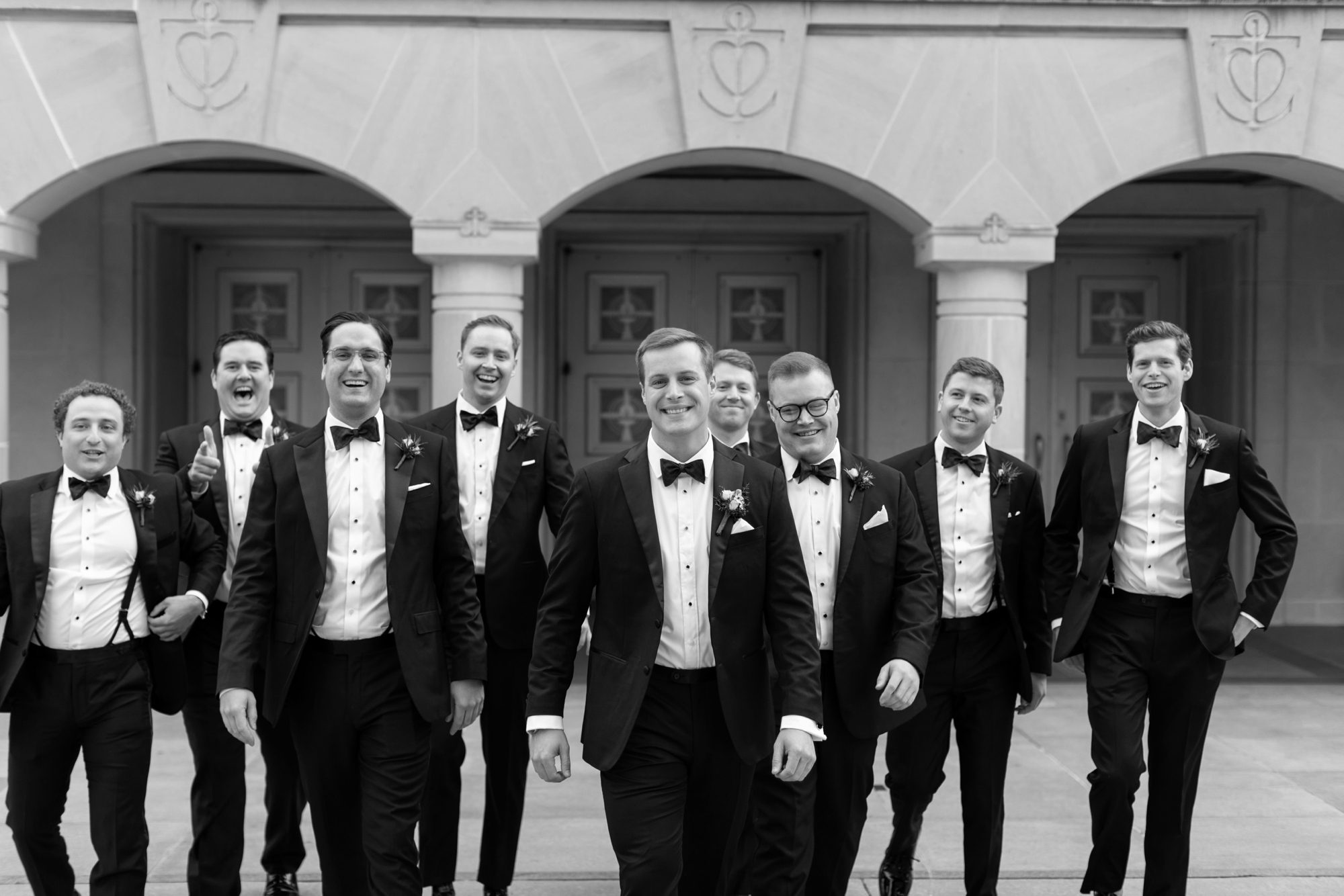 the groom and groomsmen wore classic black tuxedos