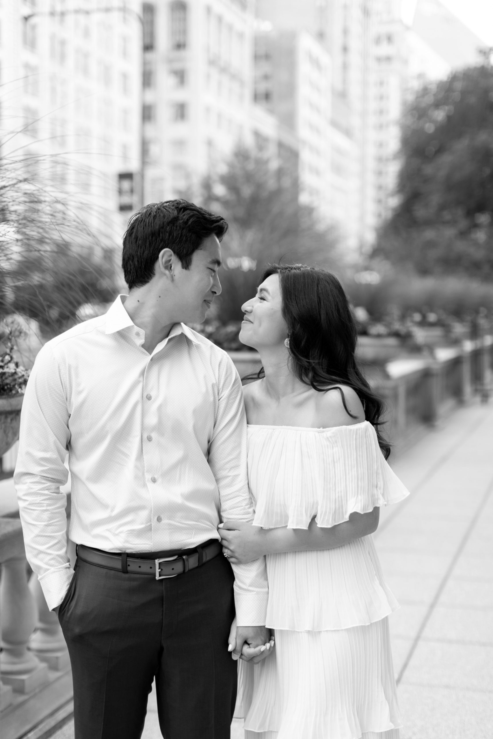 the couple smiled at each other during their summer engagement photos in Chicago