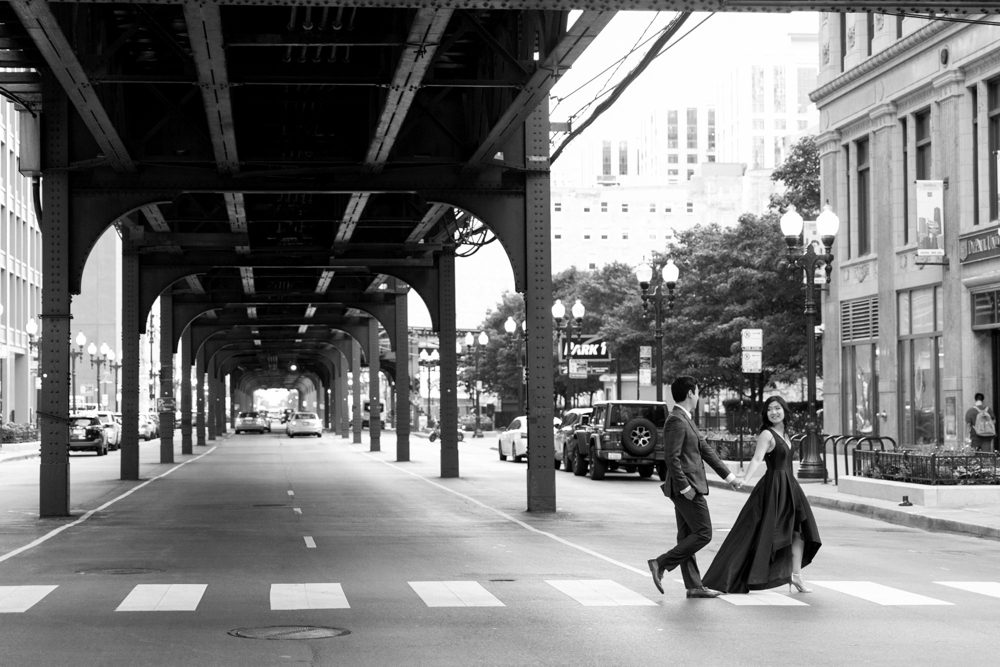 the couple walked in downtown Chicago during their summer engagement photo shoot