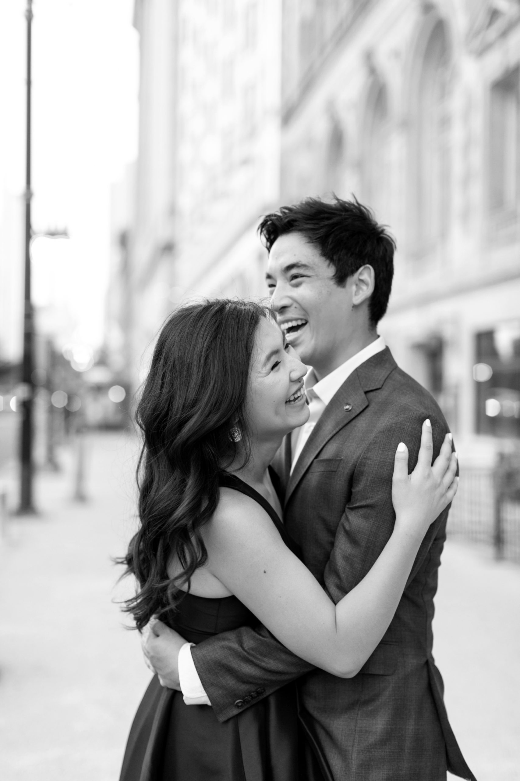 the man and woman laughed during their downtown Chicago summer engagement photos