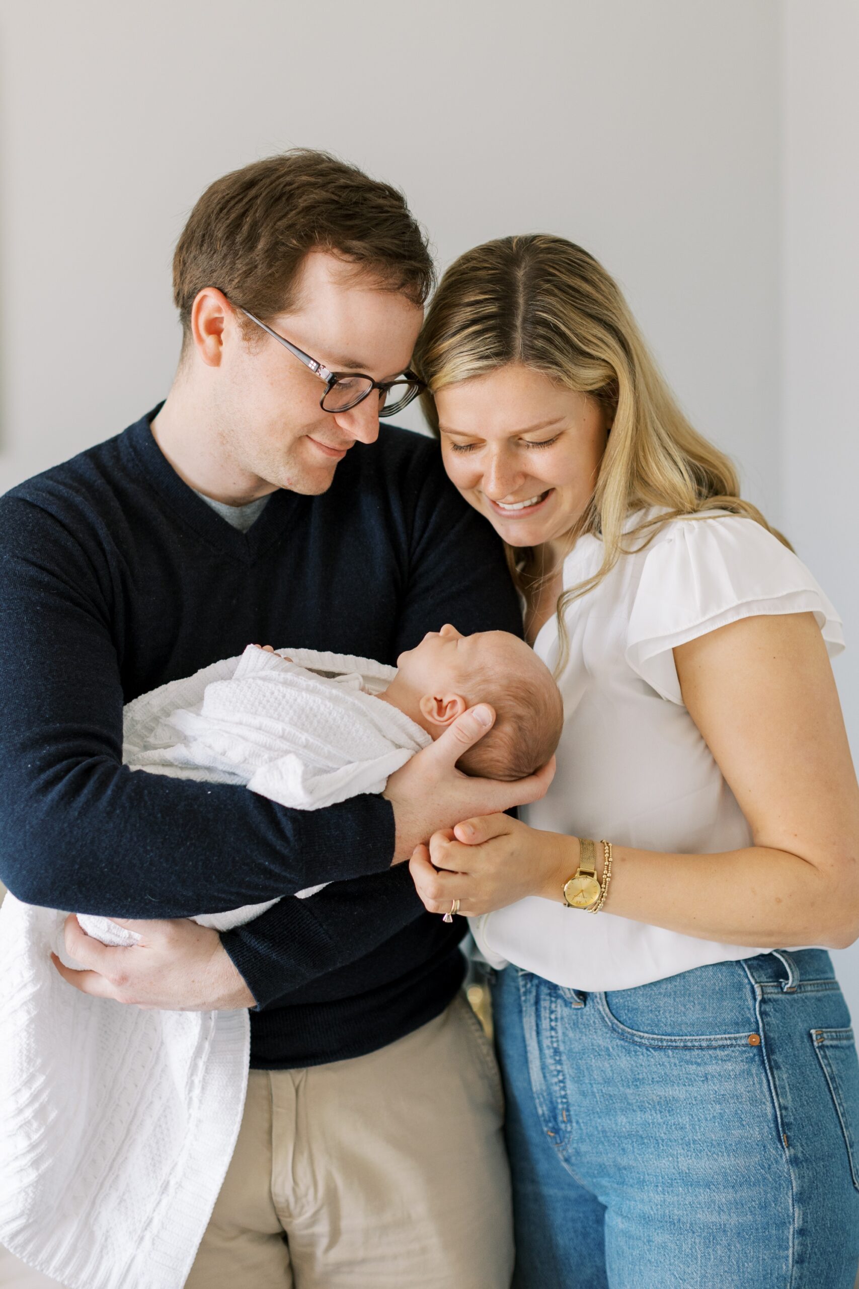 parents smile at baby during newborn photography