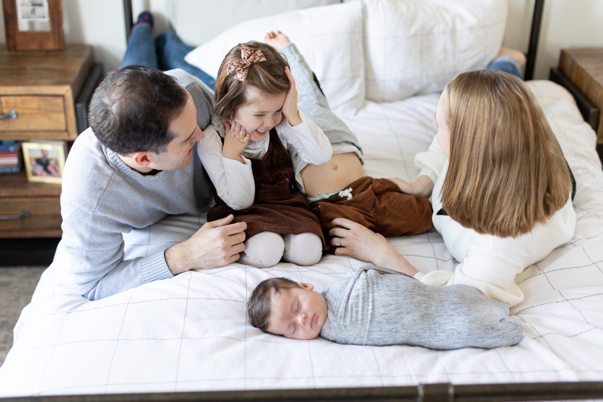 family laughs together during Chicago home photoshoot