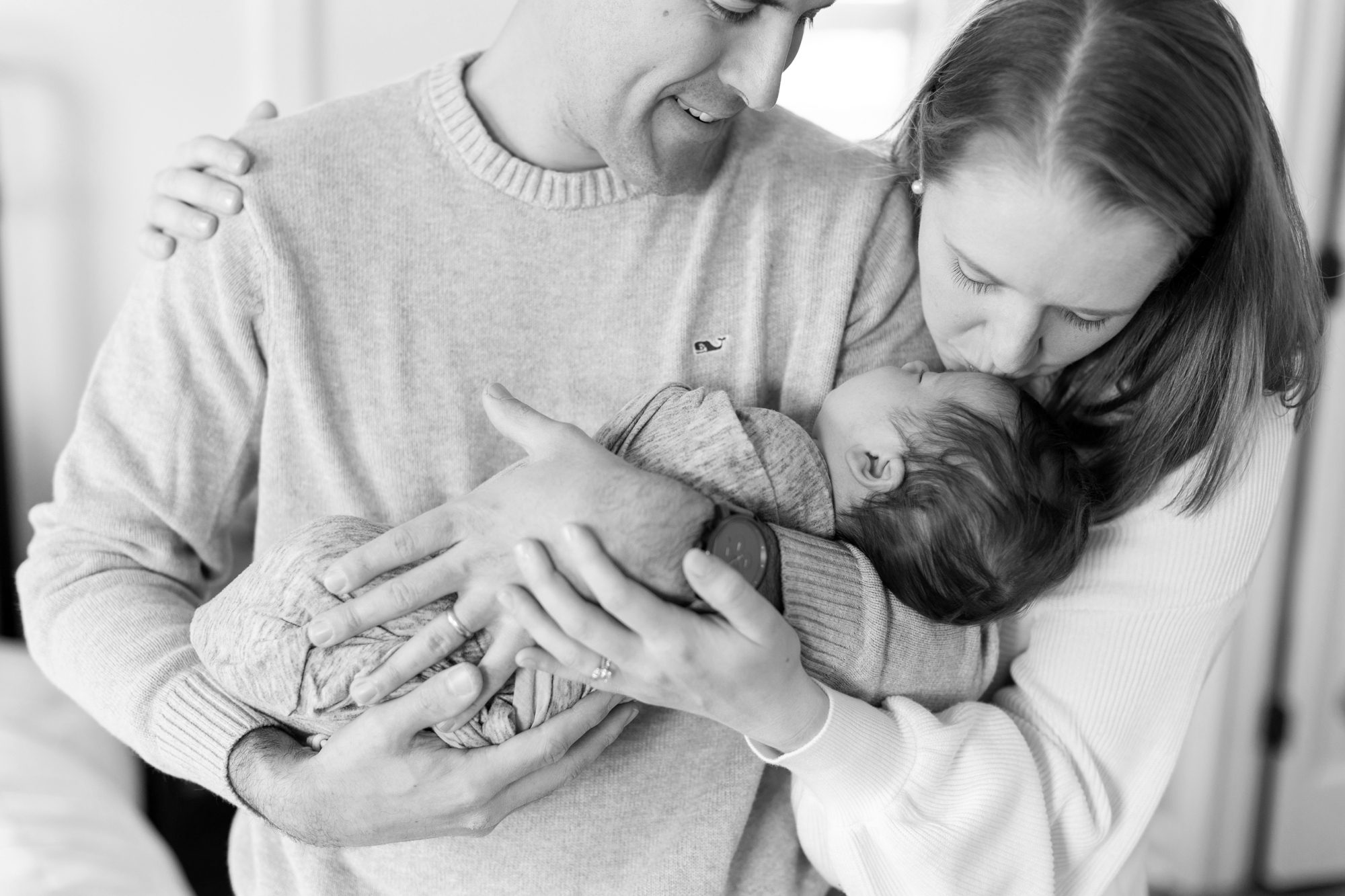 the parents kissed the baby during the newborn photos