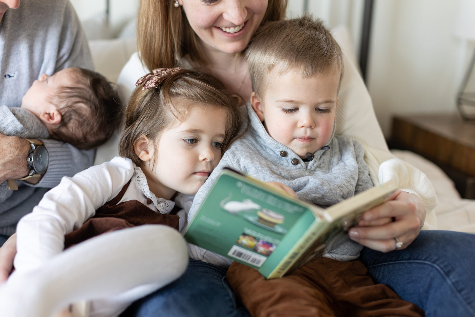 family reads a book together during family lifestyle session