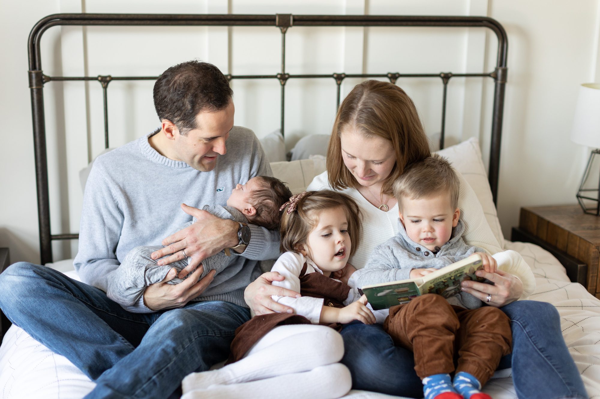 parents read a book with children during family photoshoot