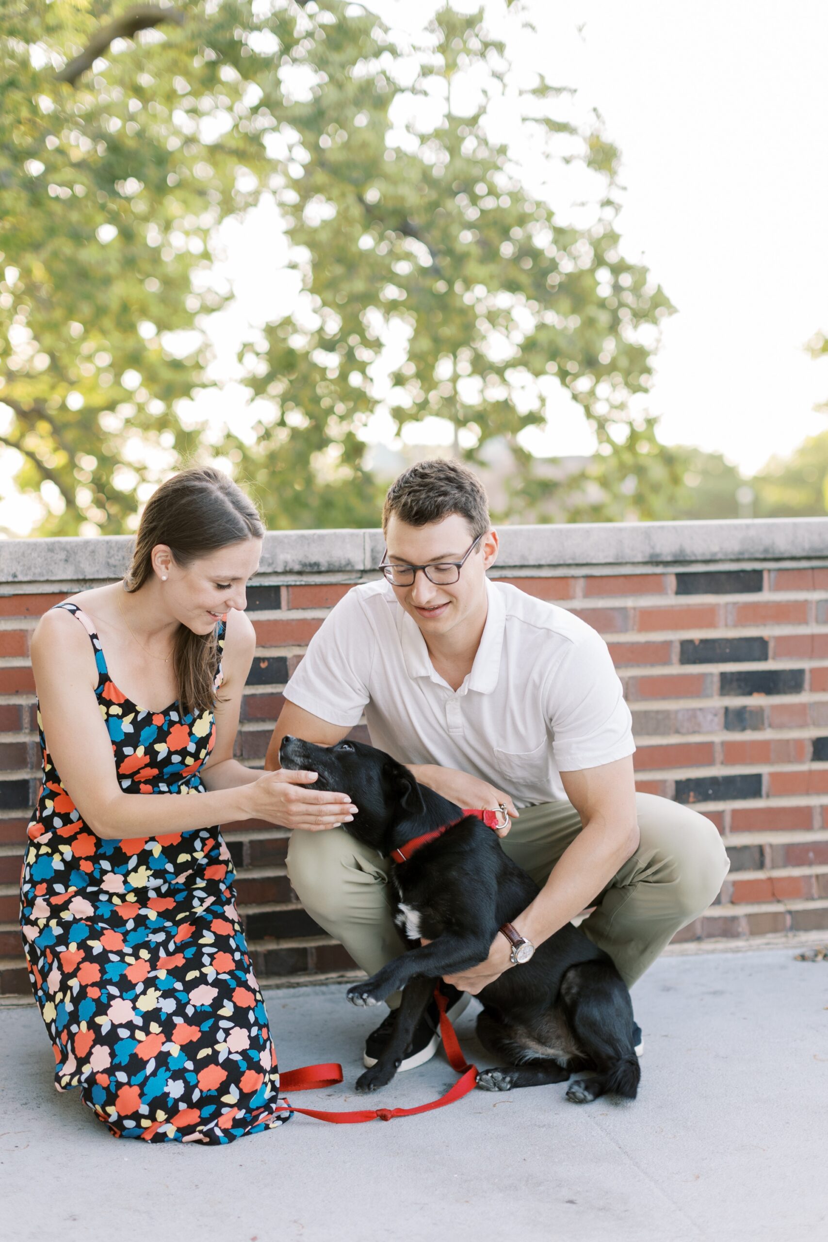 couple pets dog in Chicago during engagement photos