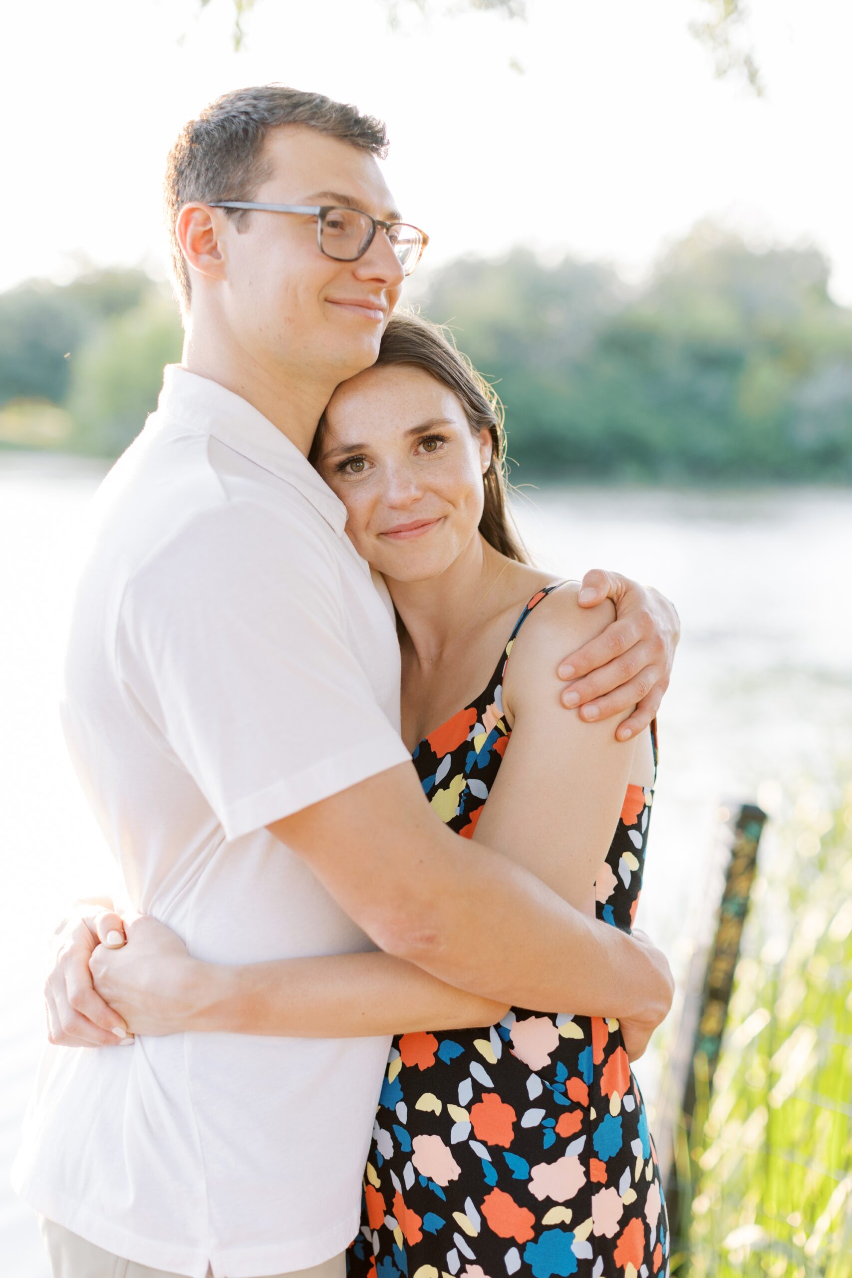 man and woman hug during engagement photos