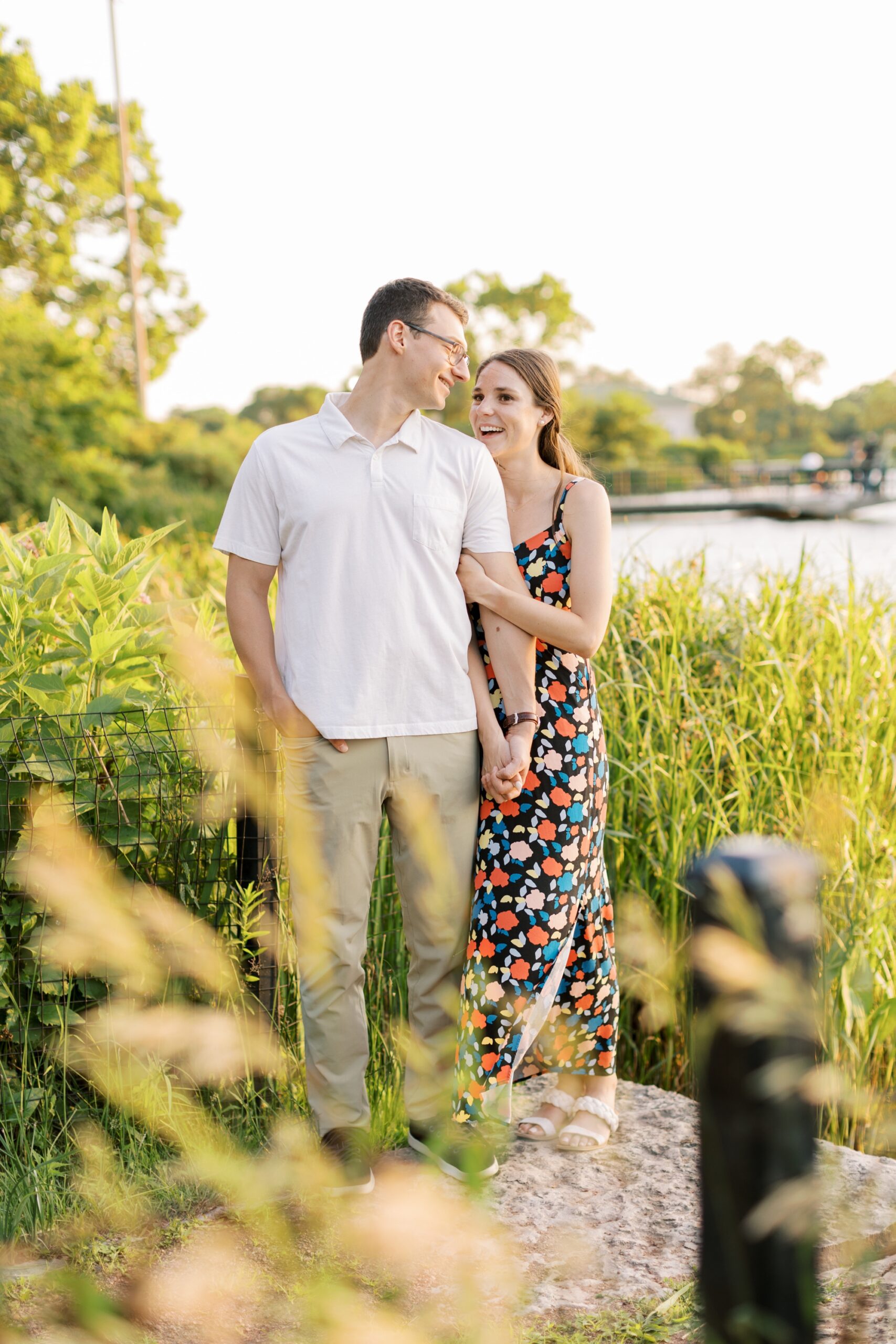 man and woman look at each other during engagement session