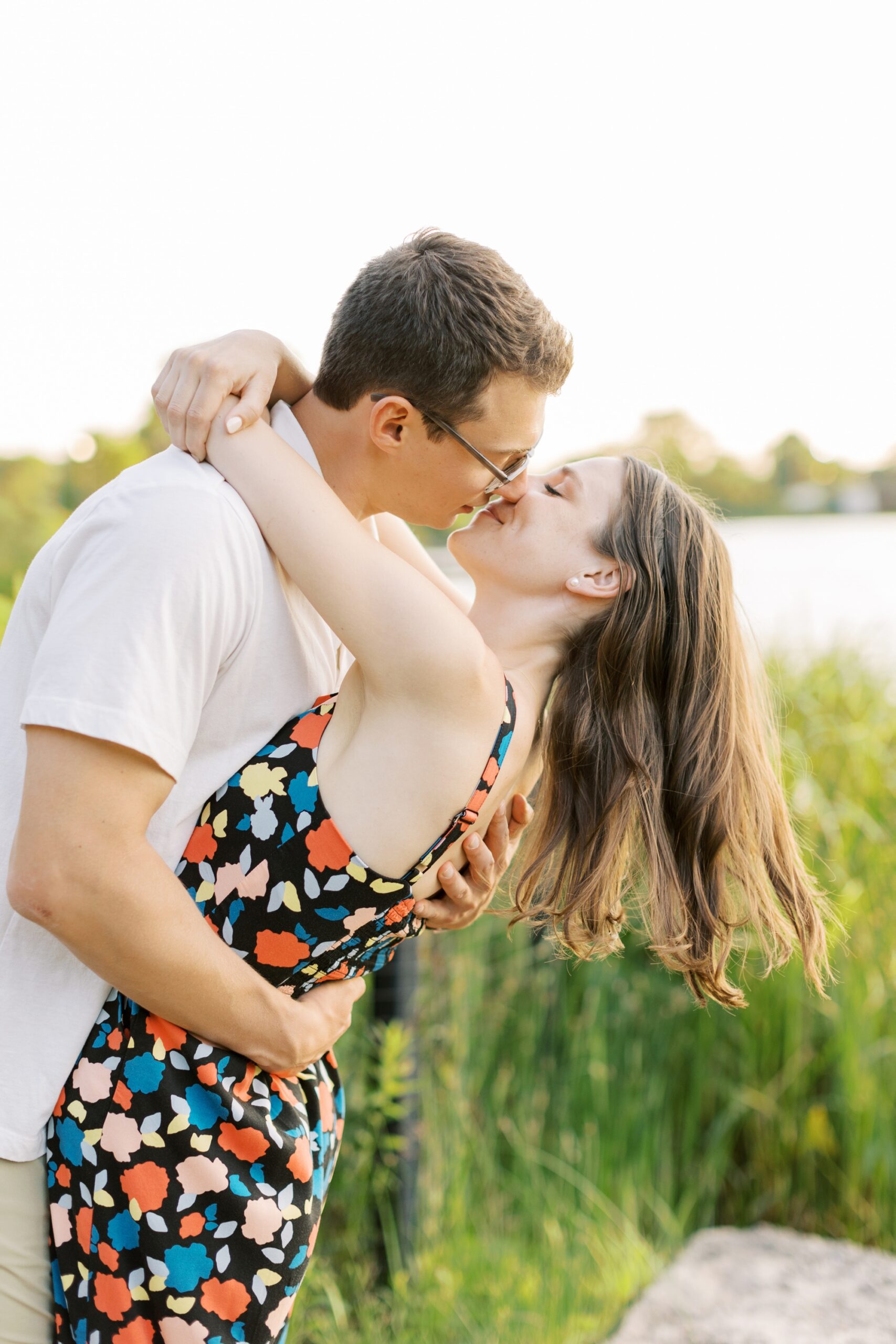 the man and woman kissed during their engagement photoshoot