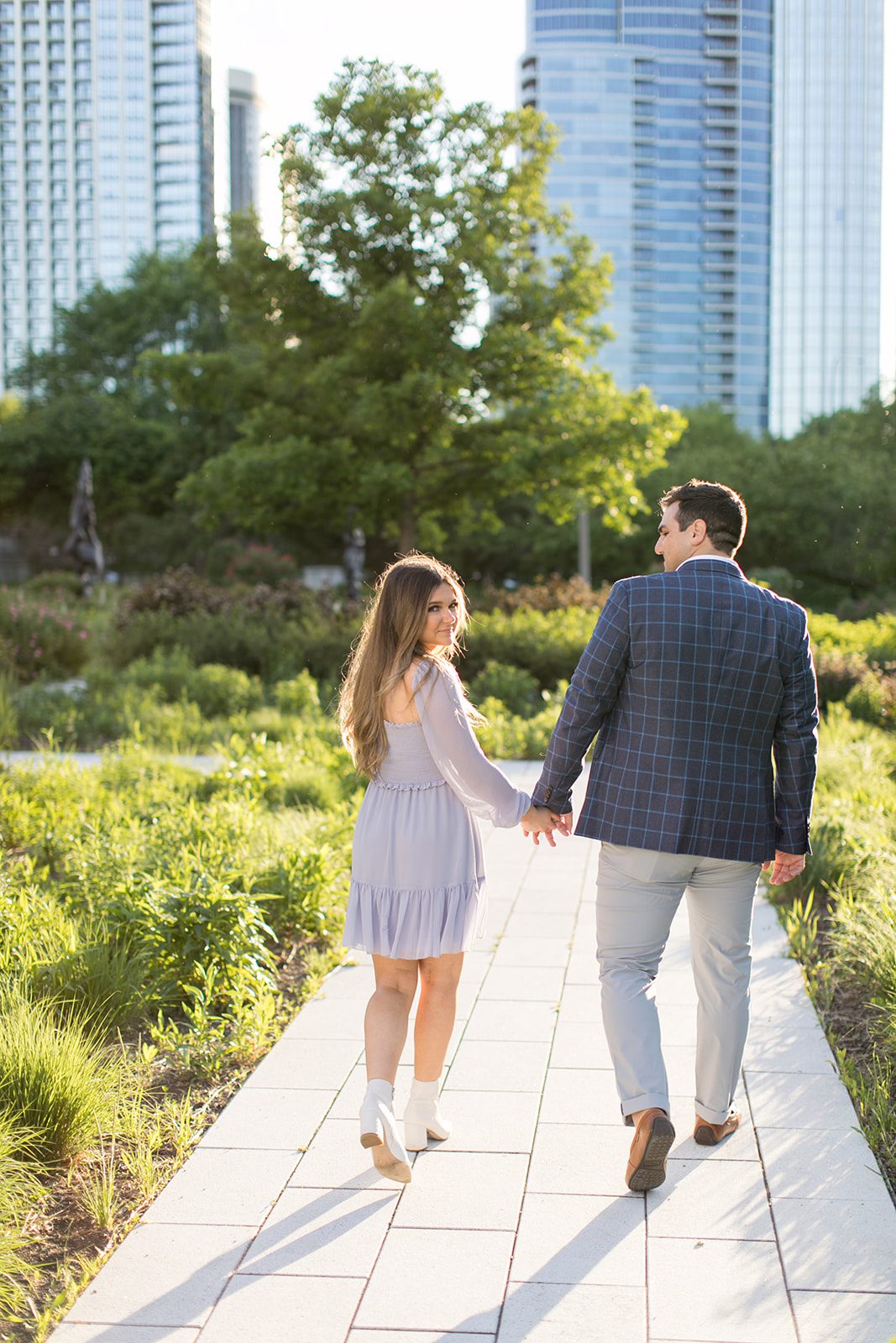 man and woman walk away from the camera during chicago engagement photos