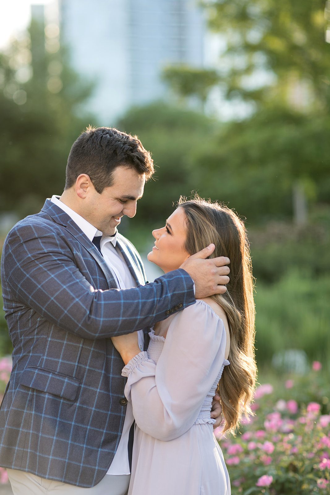 man pushes hair behind woman's ear during engagement photoshoot