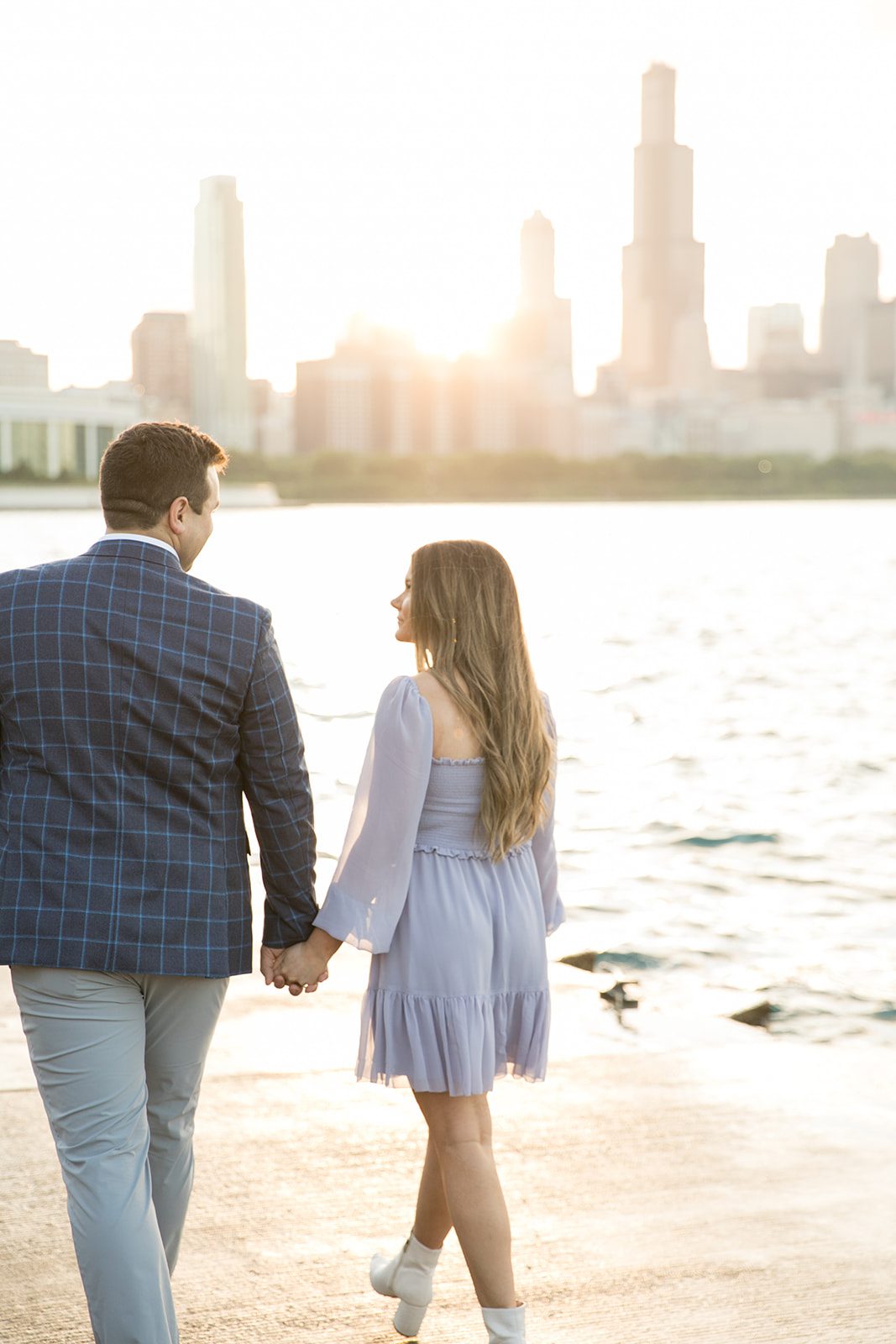 man and woman walk along Chicago skyline