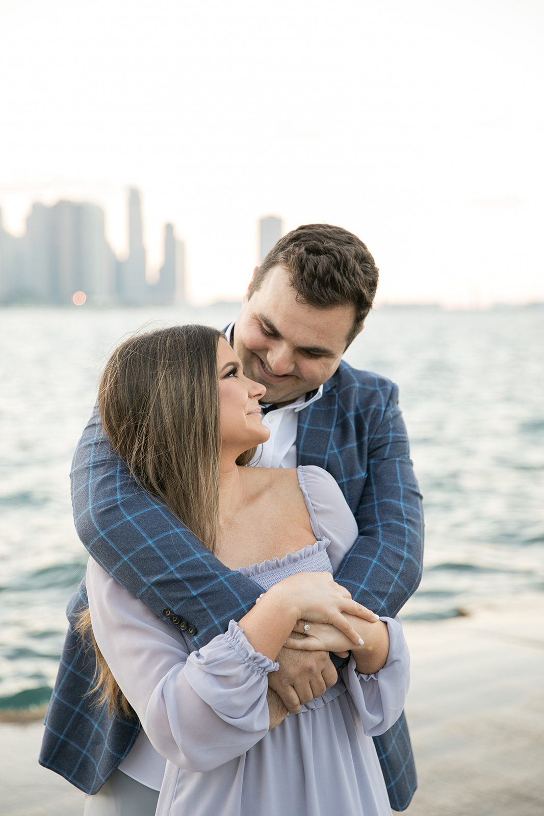 man and woman smile at each other for Chicago engagement photos