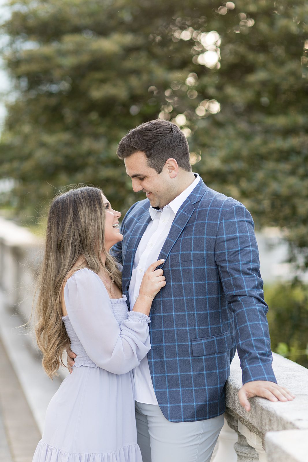 man and woman smile at each other during Chicago engagement photos