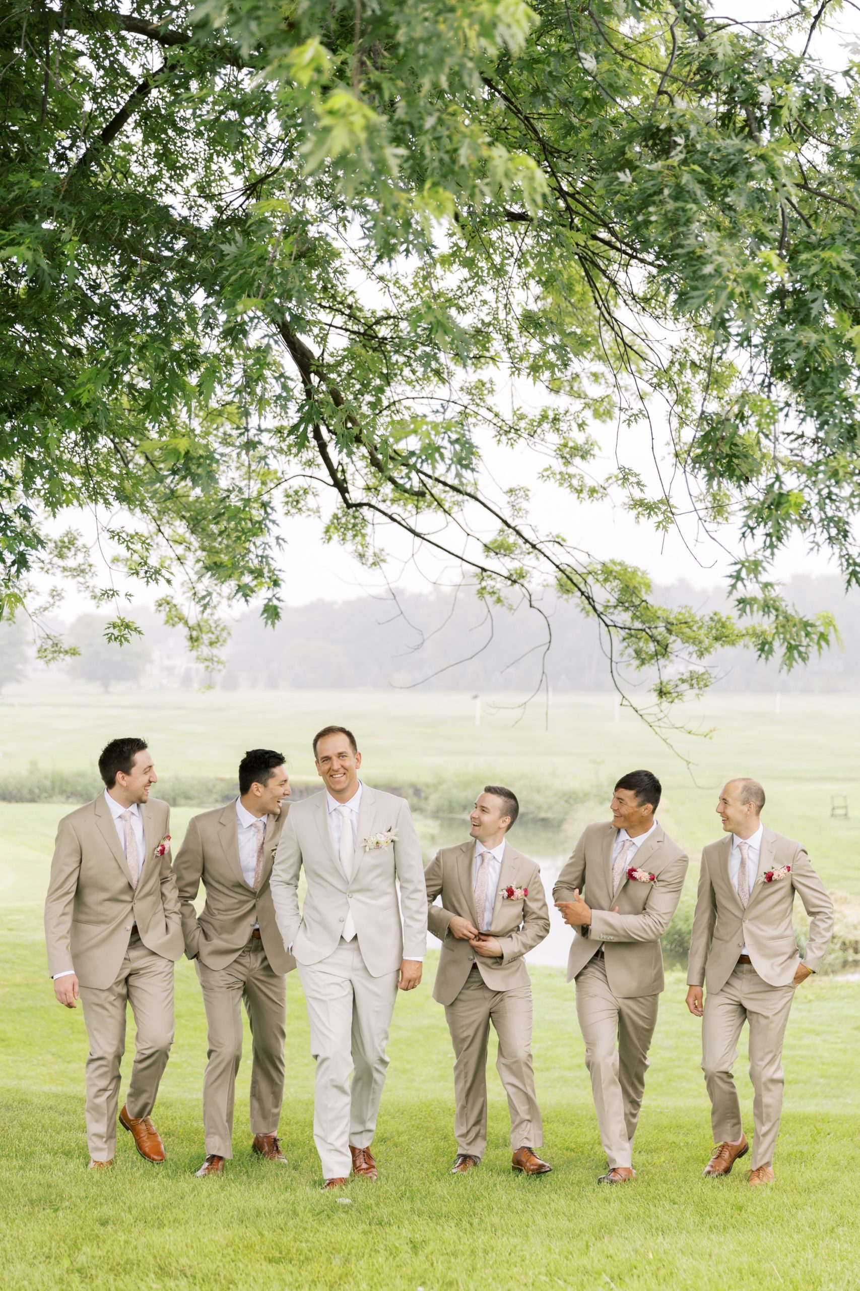 Groomsmen posing for photos at the Lake Windsor Country Club wedding