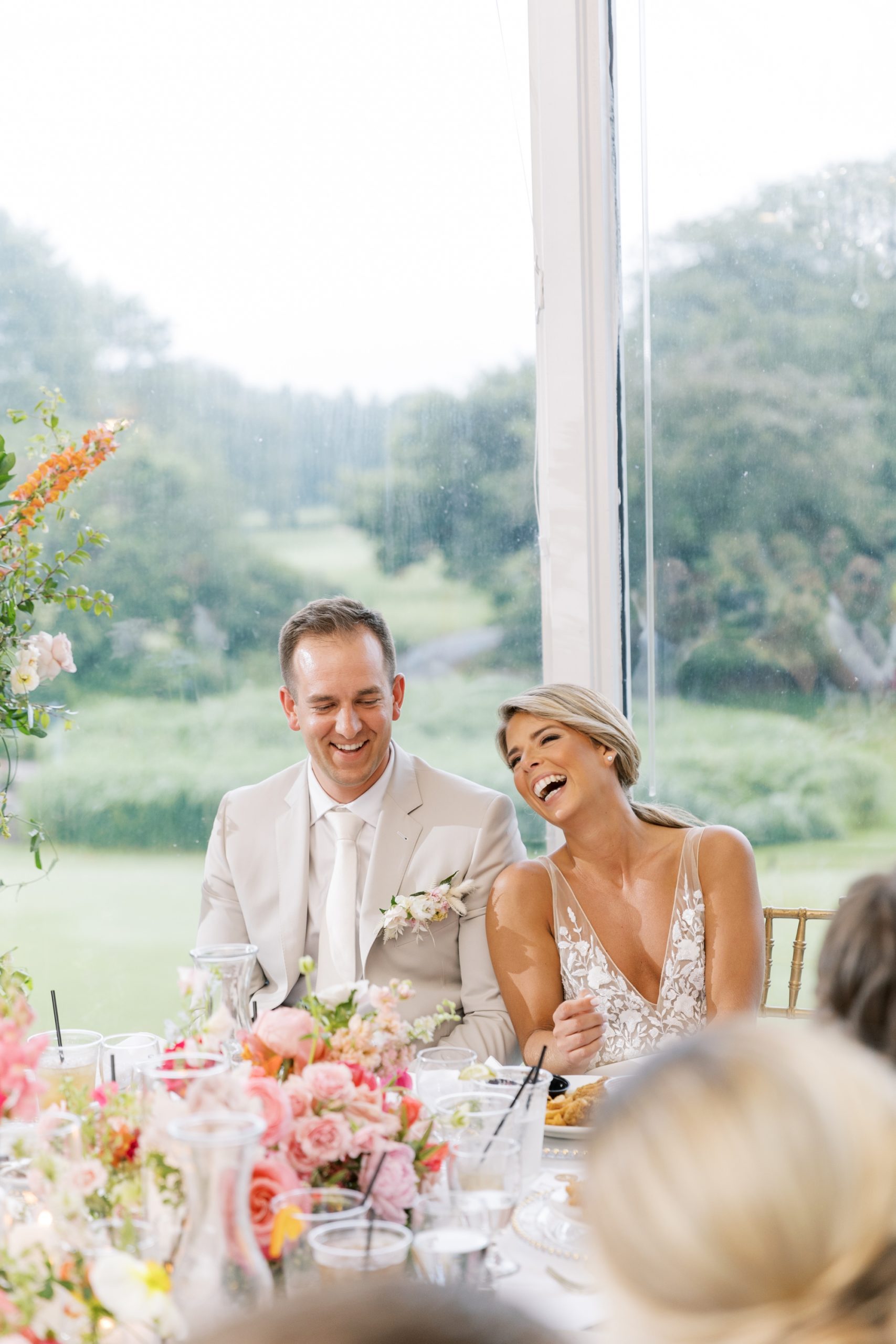 Bride and groom laughed during their reception at their Lake Windsor Country Club wedding