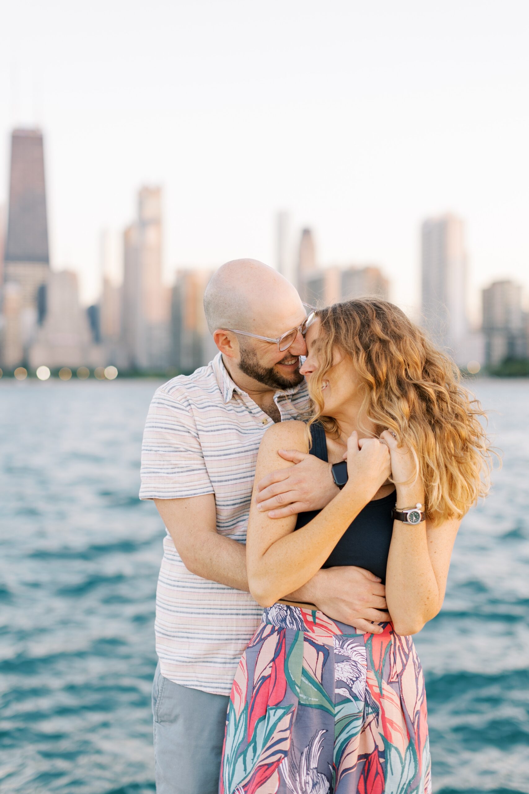 Man and woman kiss during Chicago skyline engagement photo session