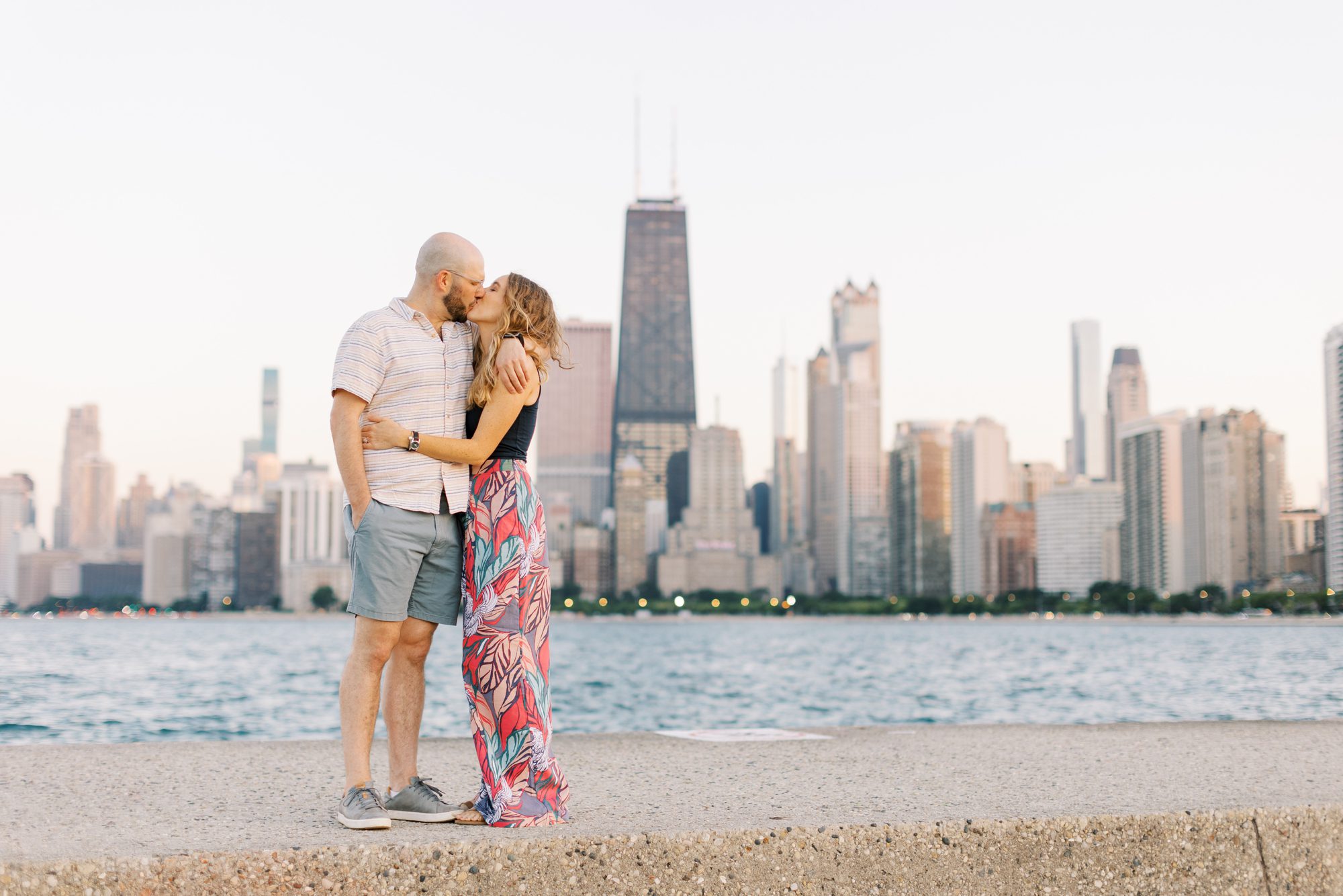 Couple kisses during Chicago skyline engagement photos