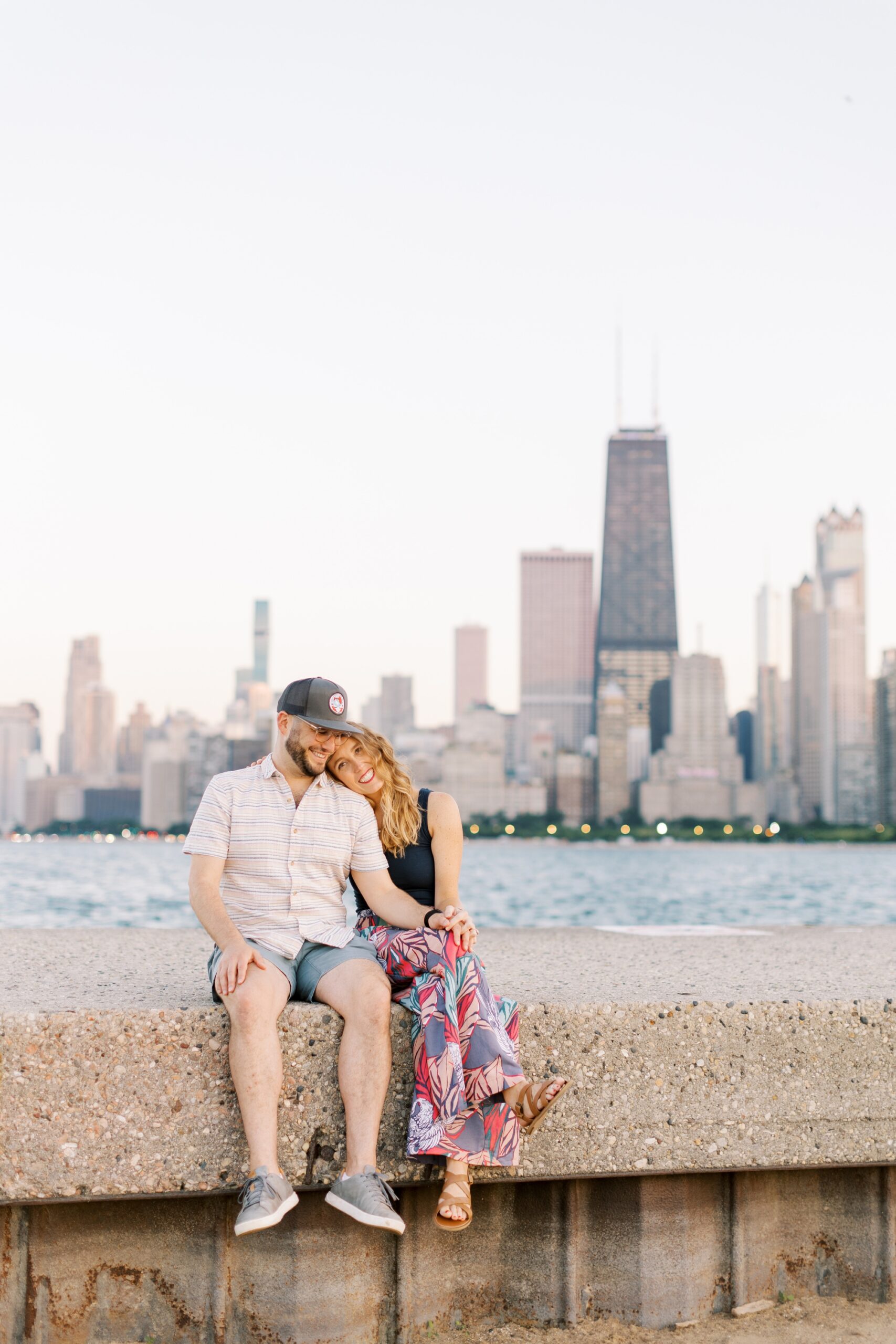 Couple laughs during Chicago skyline engagement photoshoot