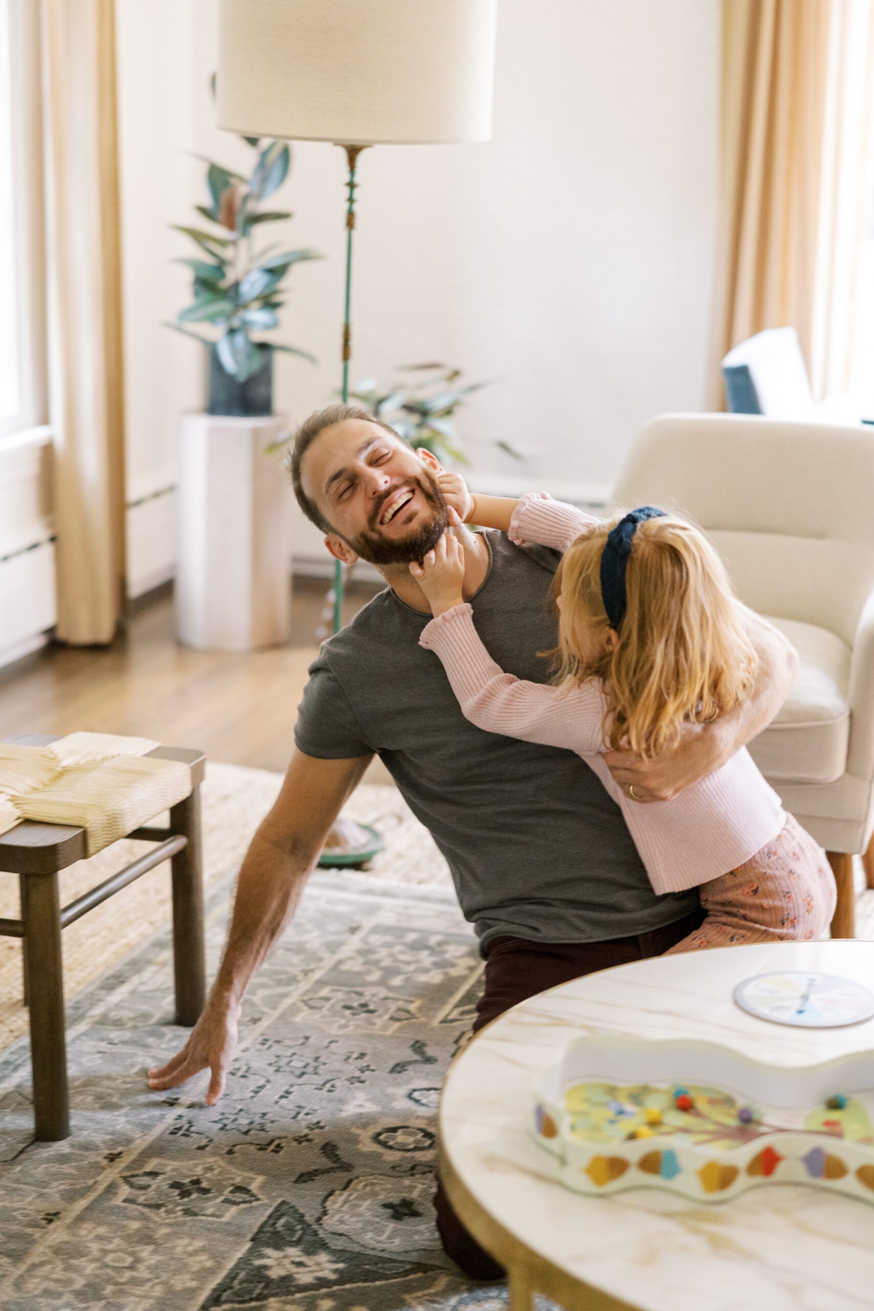 The dad and daughter laughed and played during the Chicago home lifestyle photo session