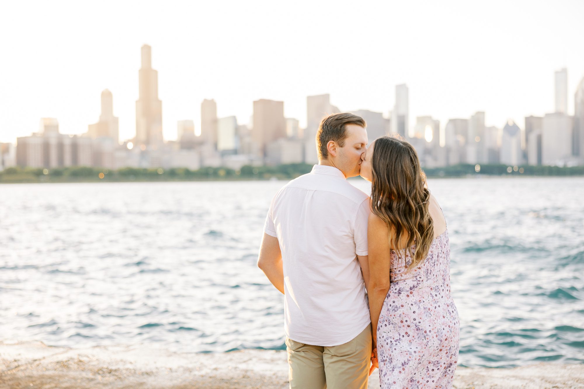 Man and woman kiss while taking their Chicago Museum Campus engagement photos