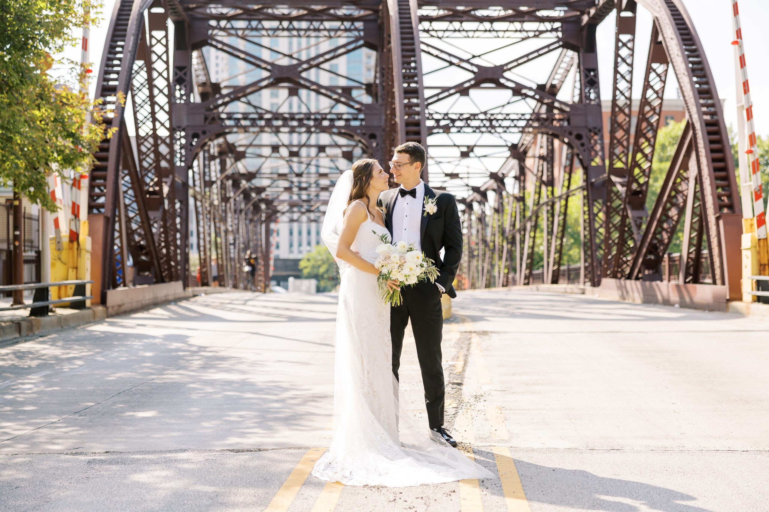 bride and groom pose in downtown chicago before galleria Marchetti wedding