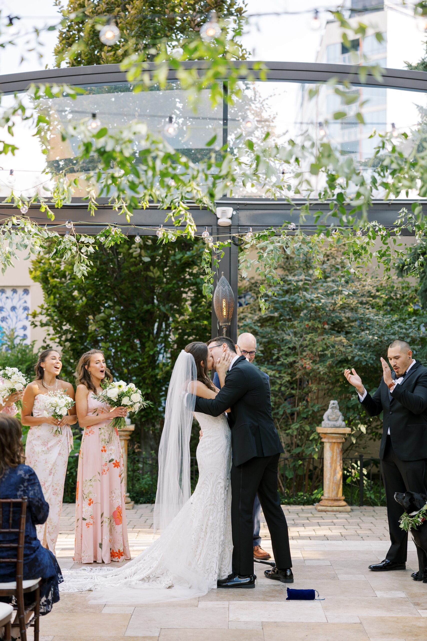 bride and groom kiss at outdoor ceremony at their galleria Marchetti wedding