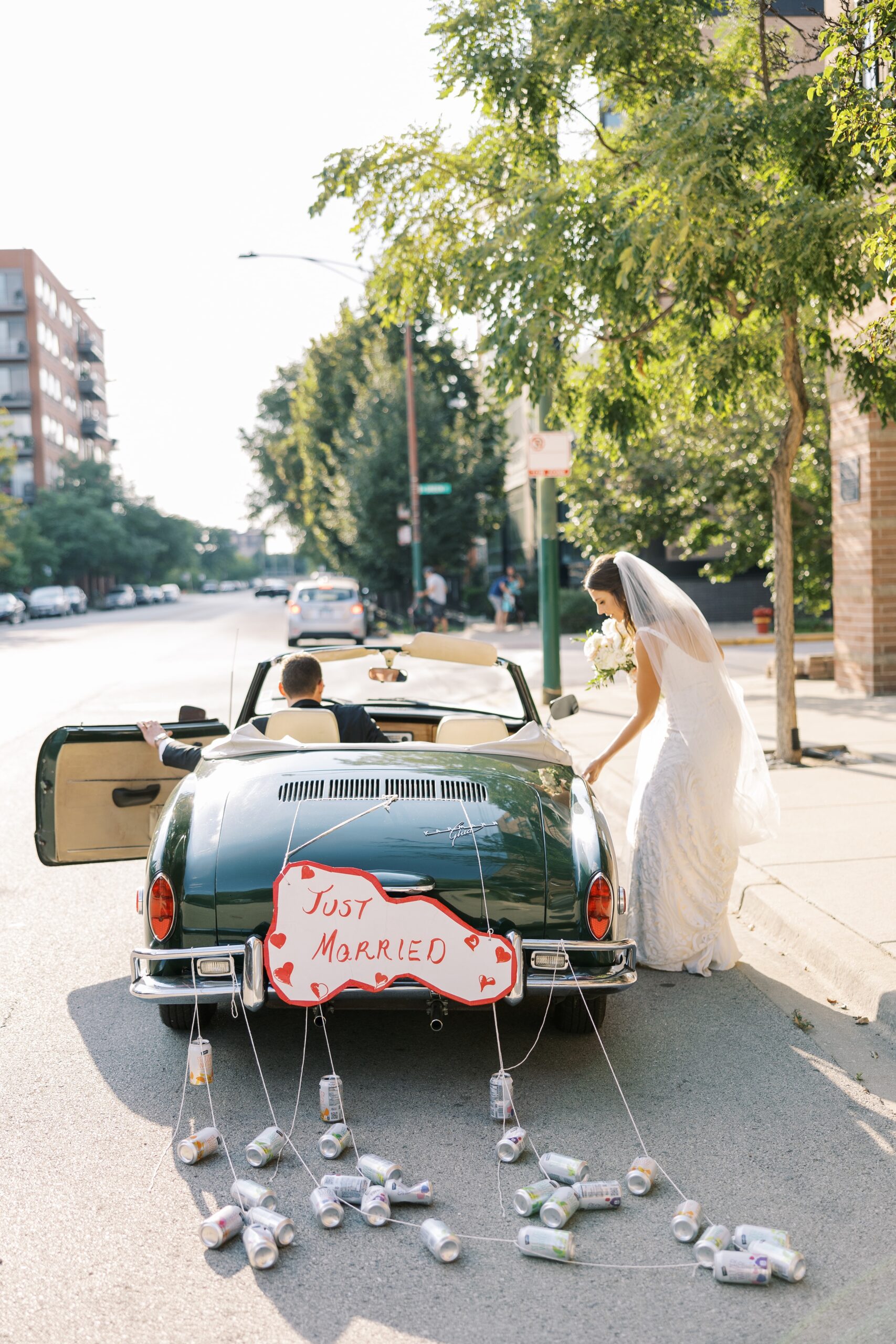 bride and groom get into vintage getaway car after their galleria Marchetti wedding