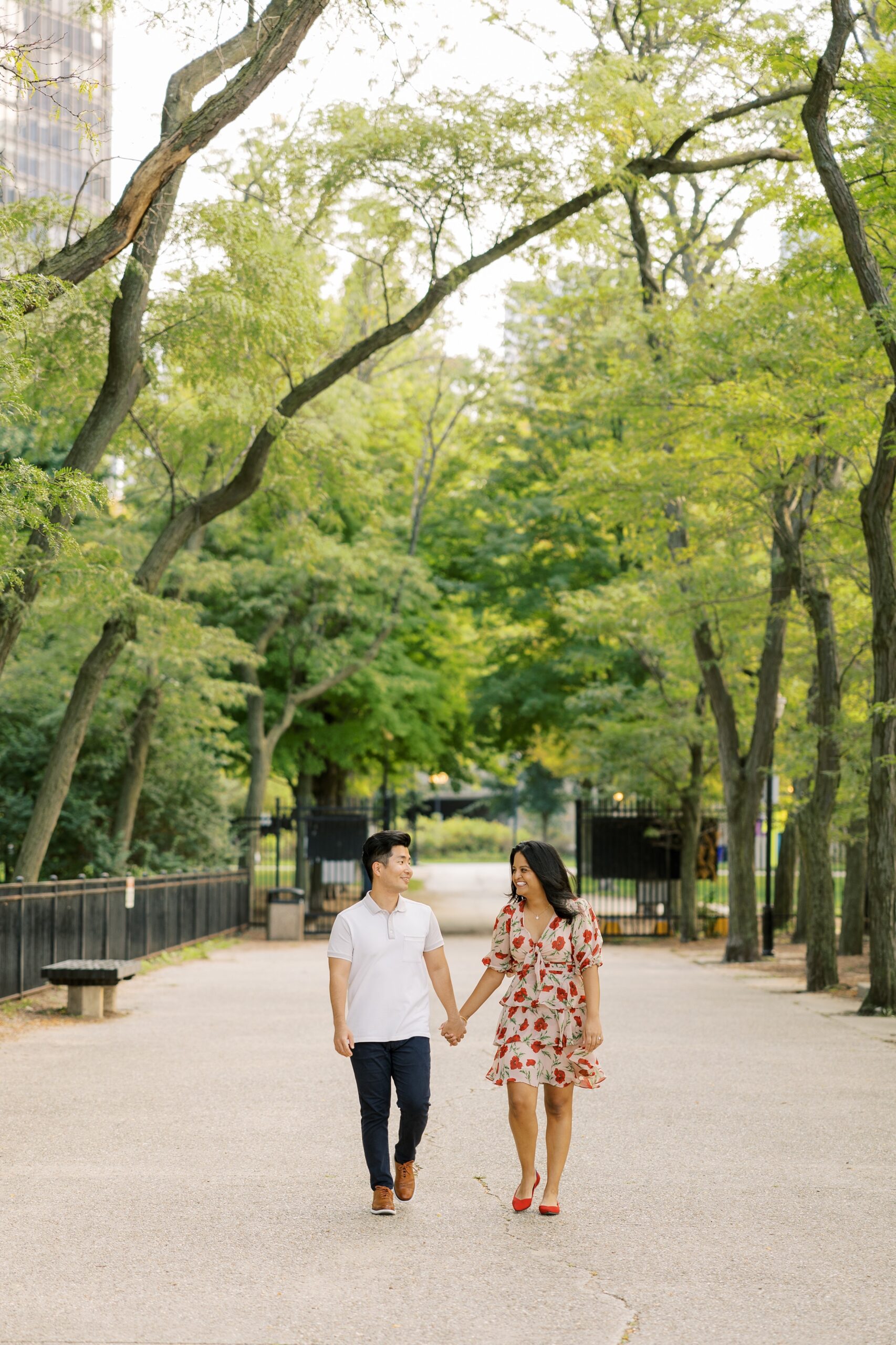 couple holding hands during outdoor engagement photos in Chicago