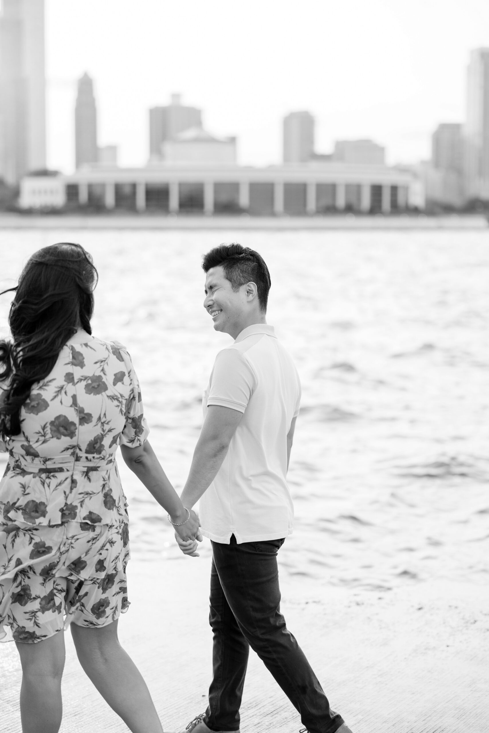 man and woman walk holding hands during chicago engagement session