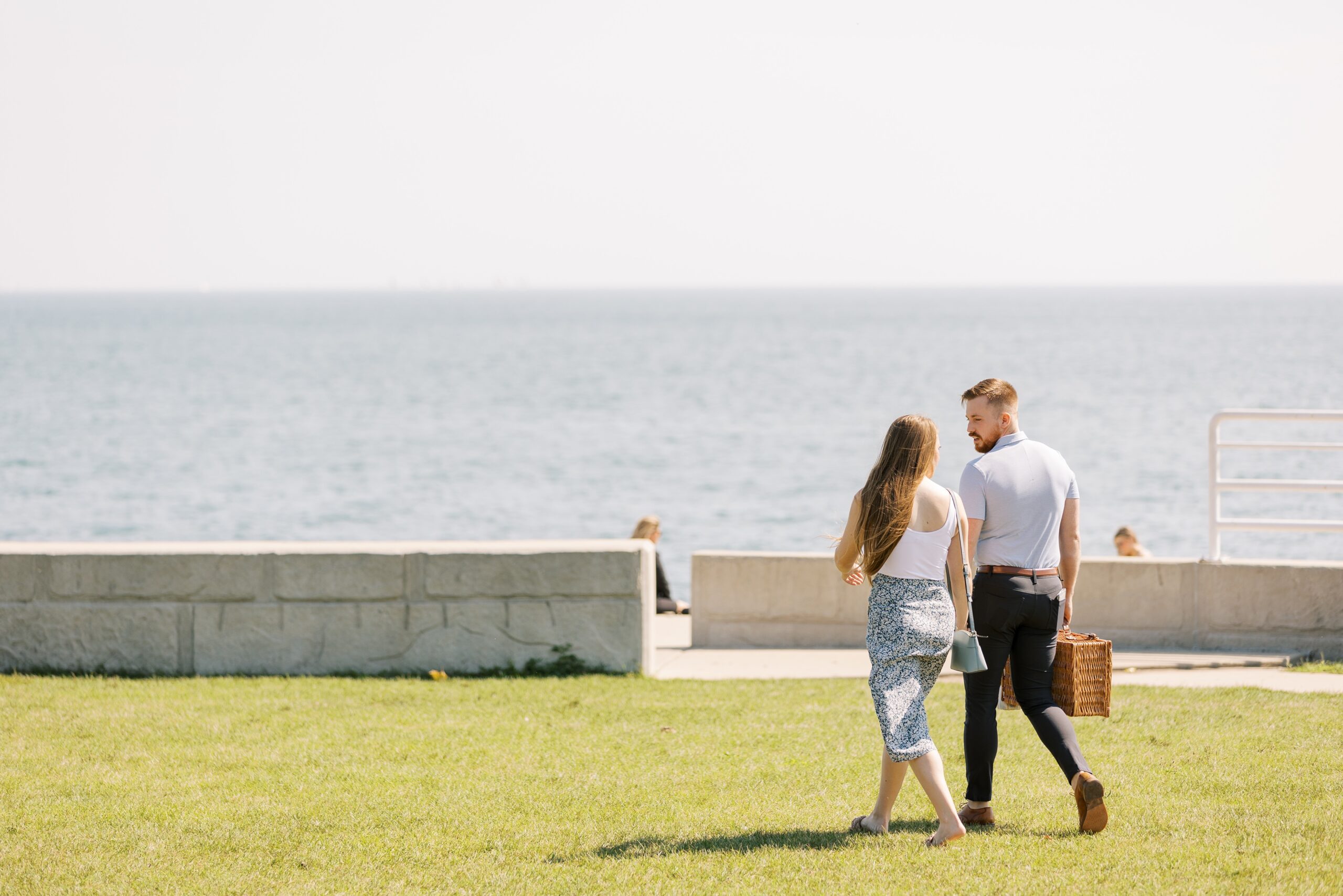 couple walking to their Chicago lakefront proposal location