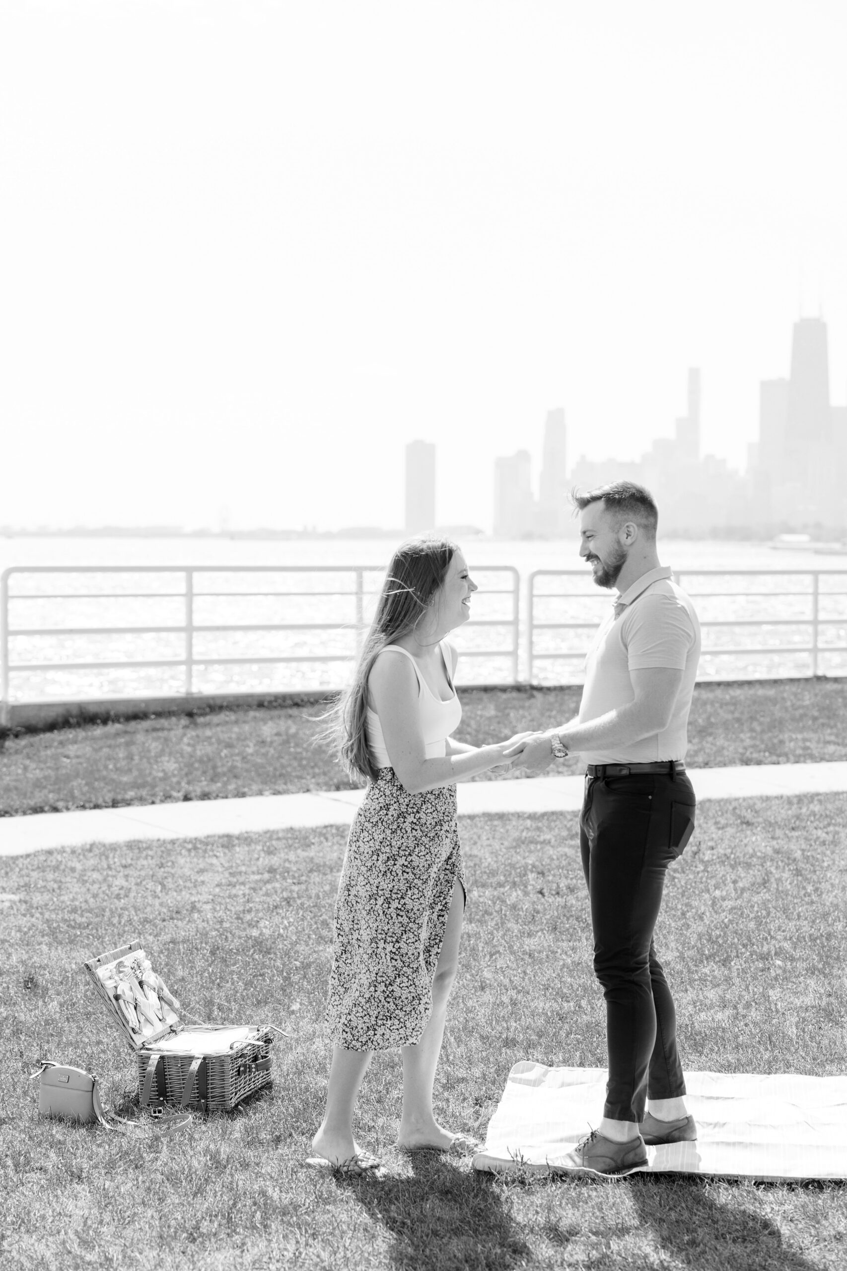 man and woman laugh after chicago lakefront proposal