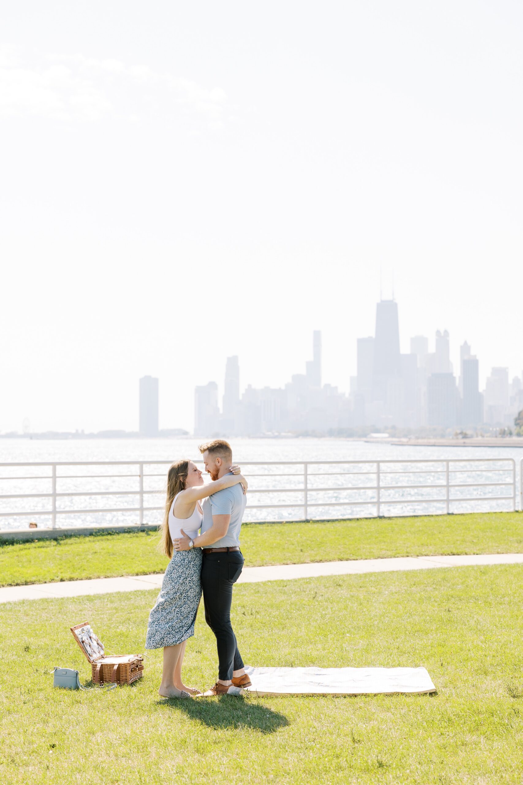 couple hugs after proposal at the Chicago lakefront