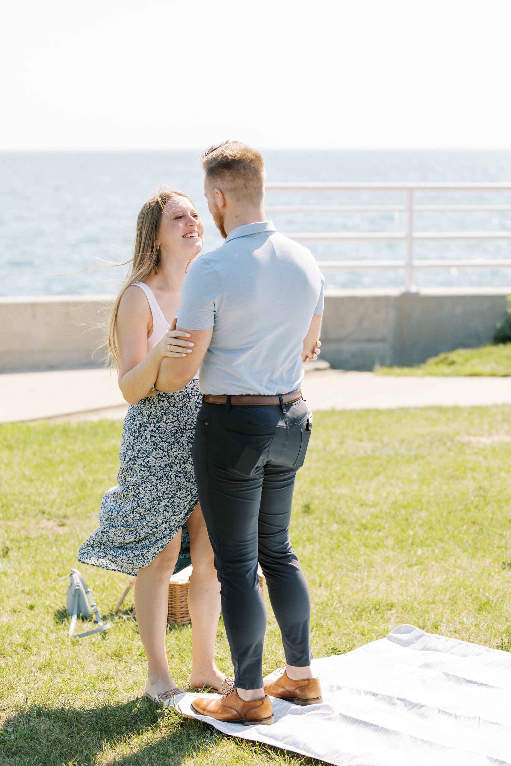 woman smiles at man after he proposes at the Chicago lakefront