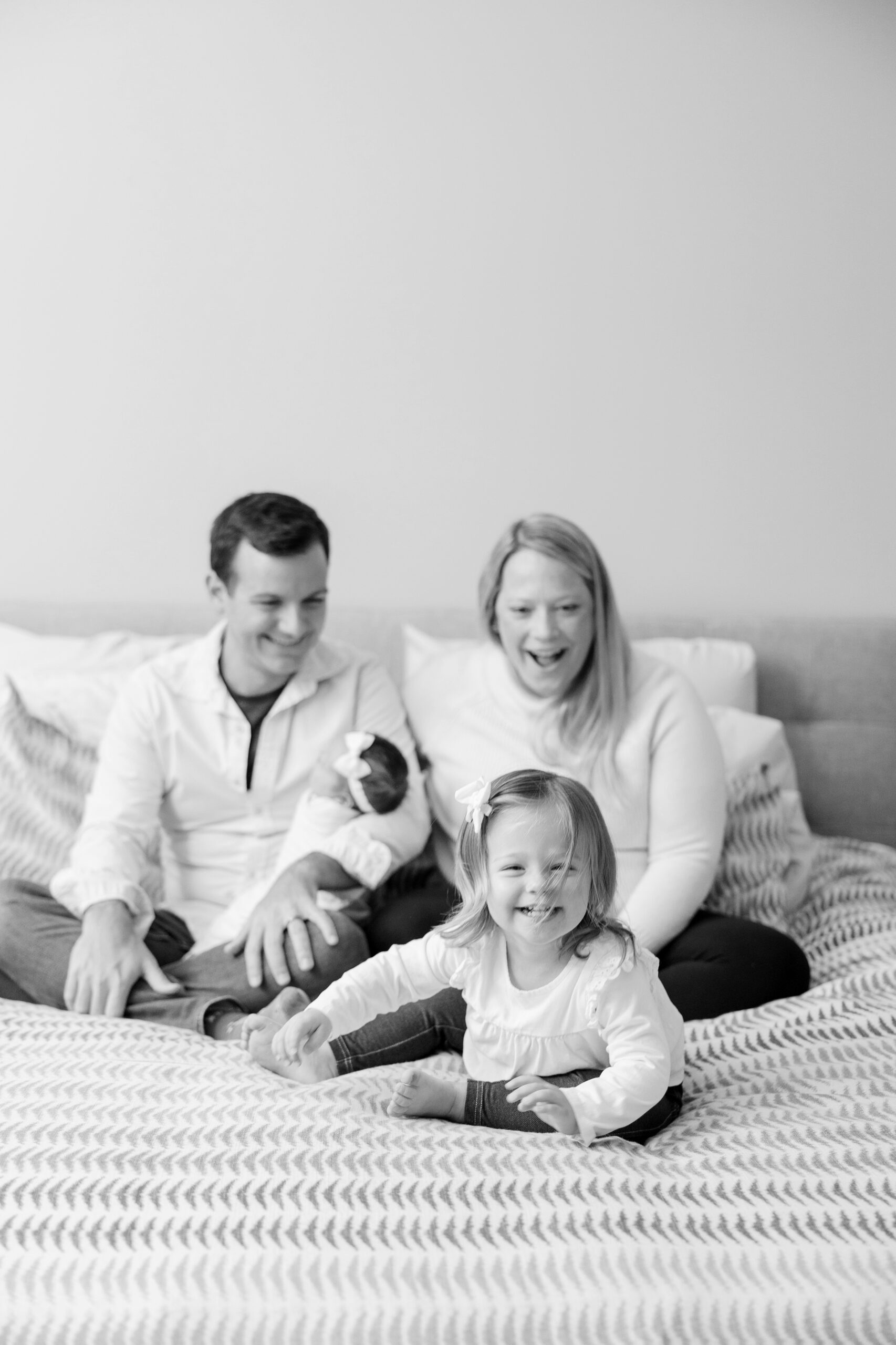 Family laughs during intimate at home newborn session