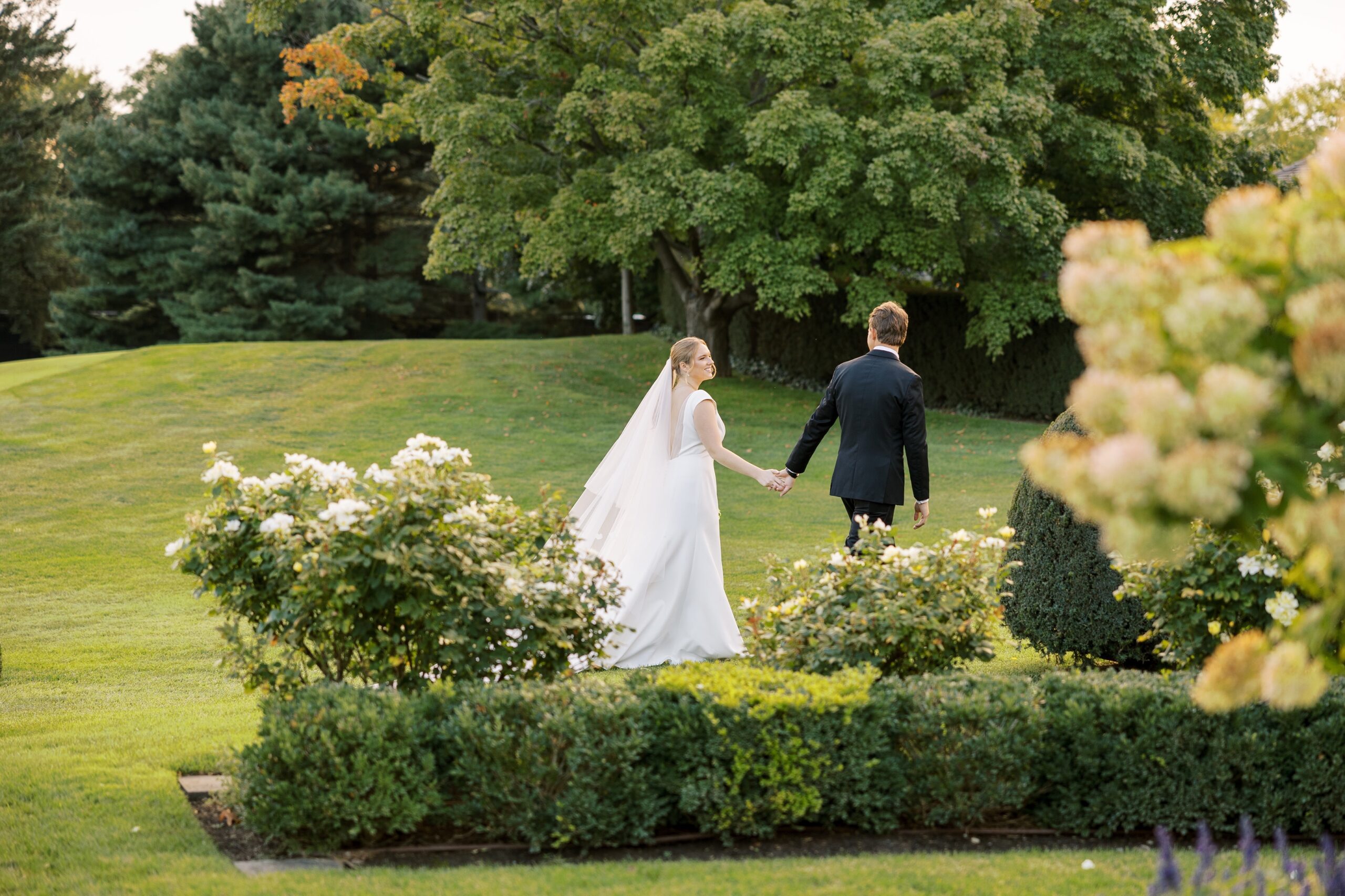 The bride and groom walked on the golf course at their Westmoreland Country Club wedding
