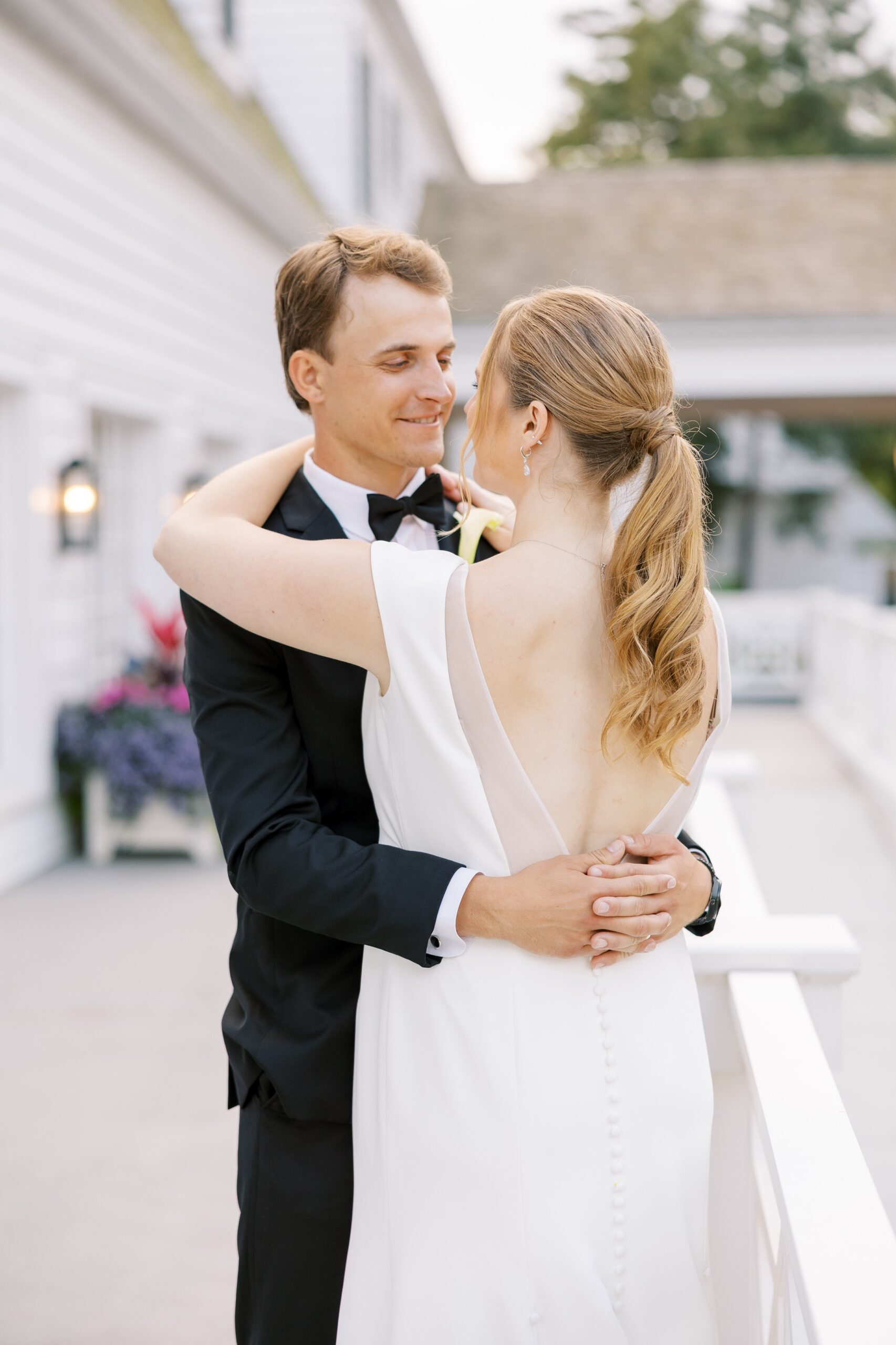 The bride and groom hugged before their Westmoreland Country Club wedding reception
