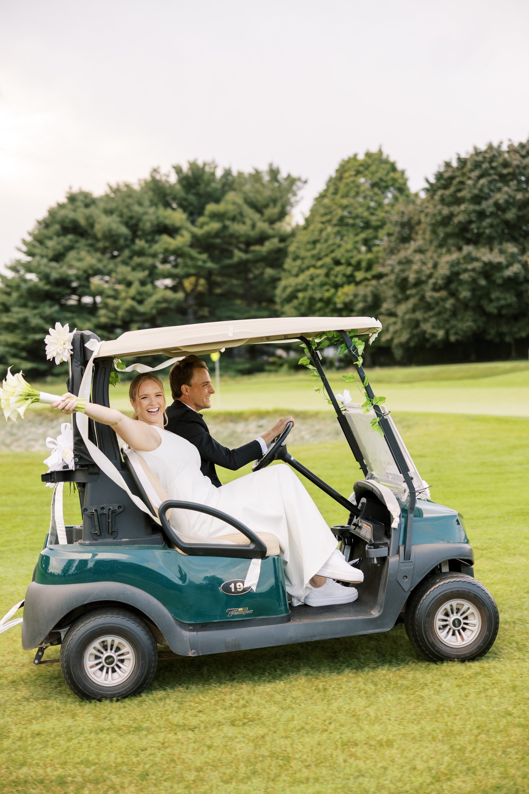 The bride and groom rode a golf cart to their Westmoreland Country Club cocktail hour