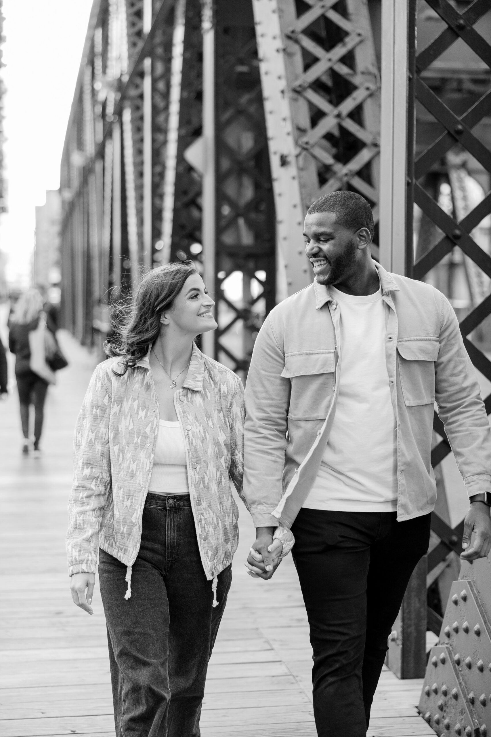 Man and woman smile at each other in Downtown Chicago engagement session