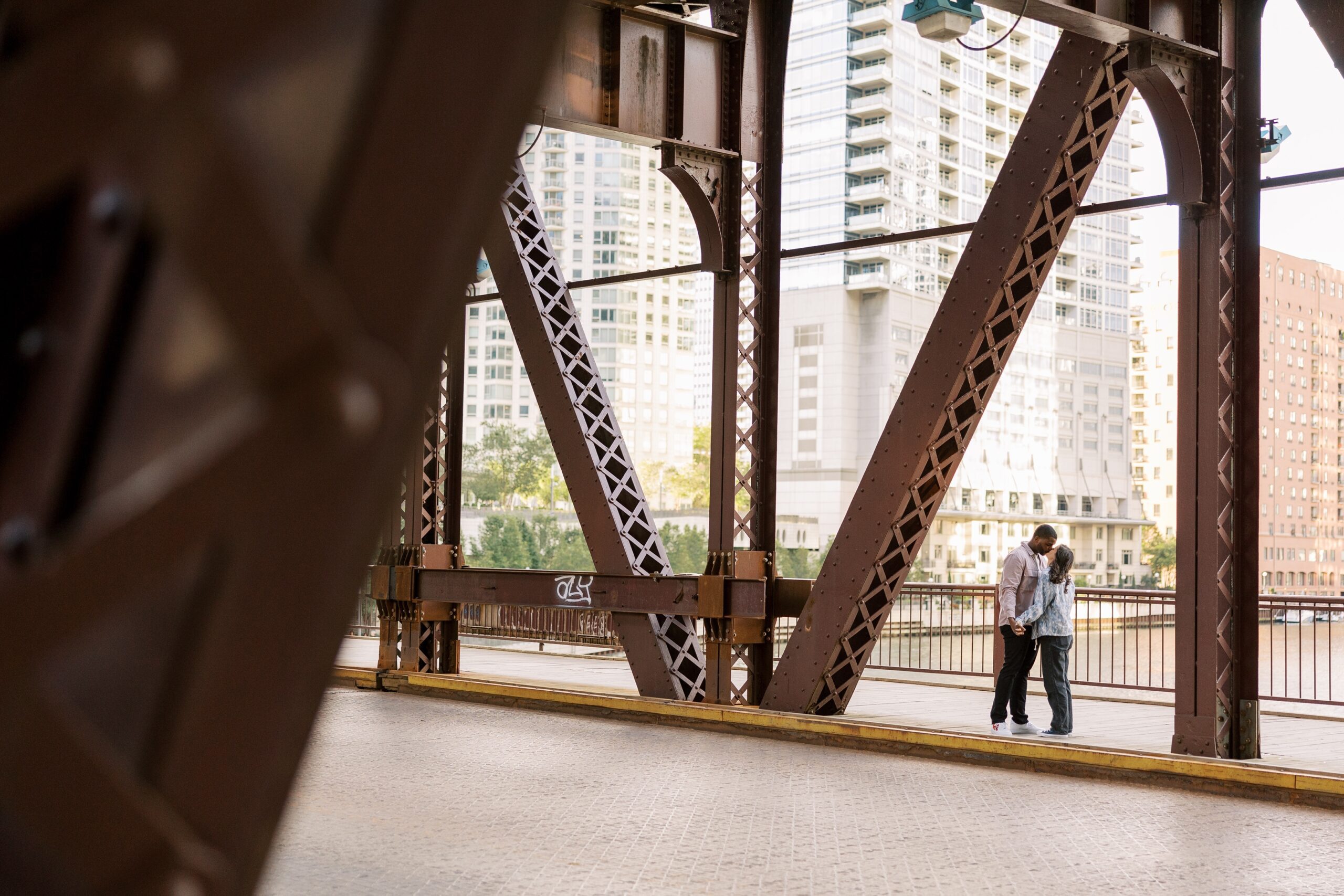 Couple kisses under bridge in downtown Chicago