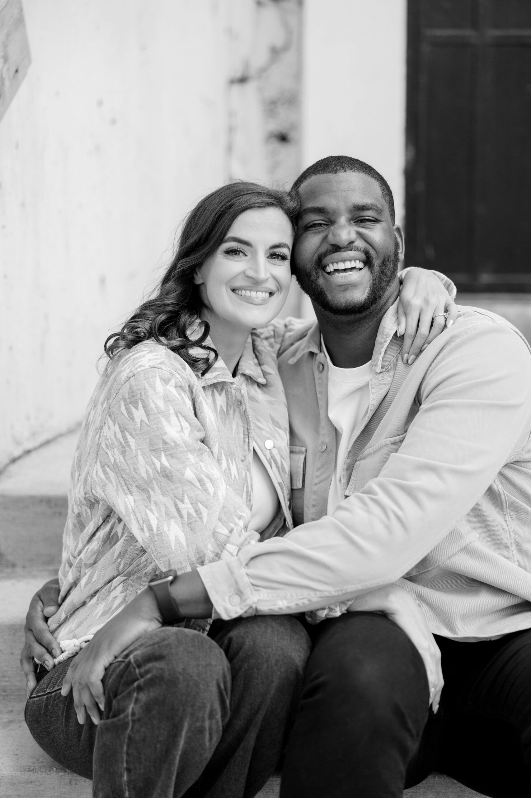 Man and woman smile at the camera during Chicago engagement photos