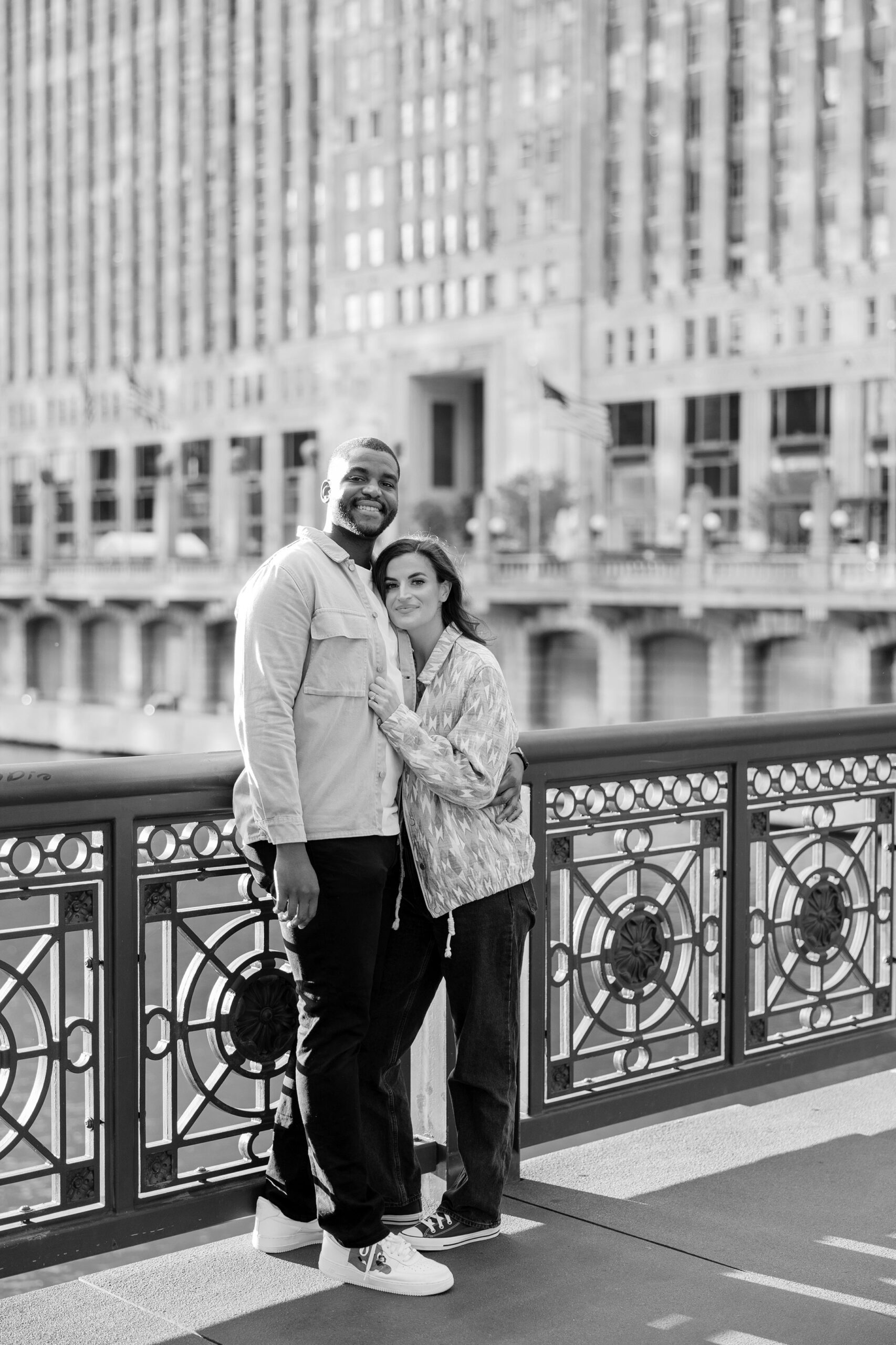 Man and woman smile at camera during Downtown Chicago engagement pictures