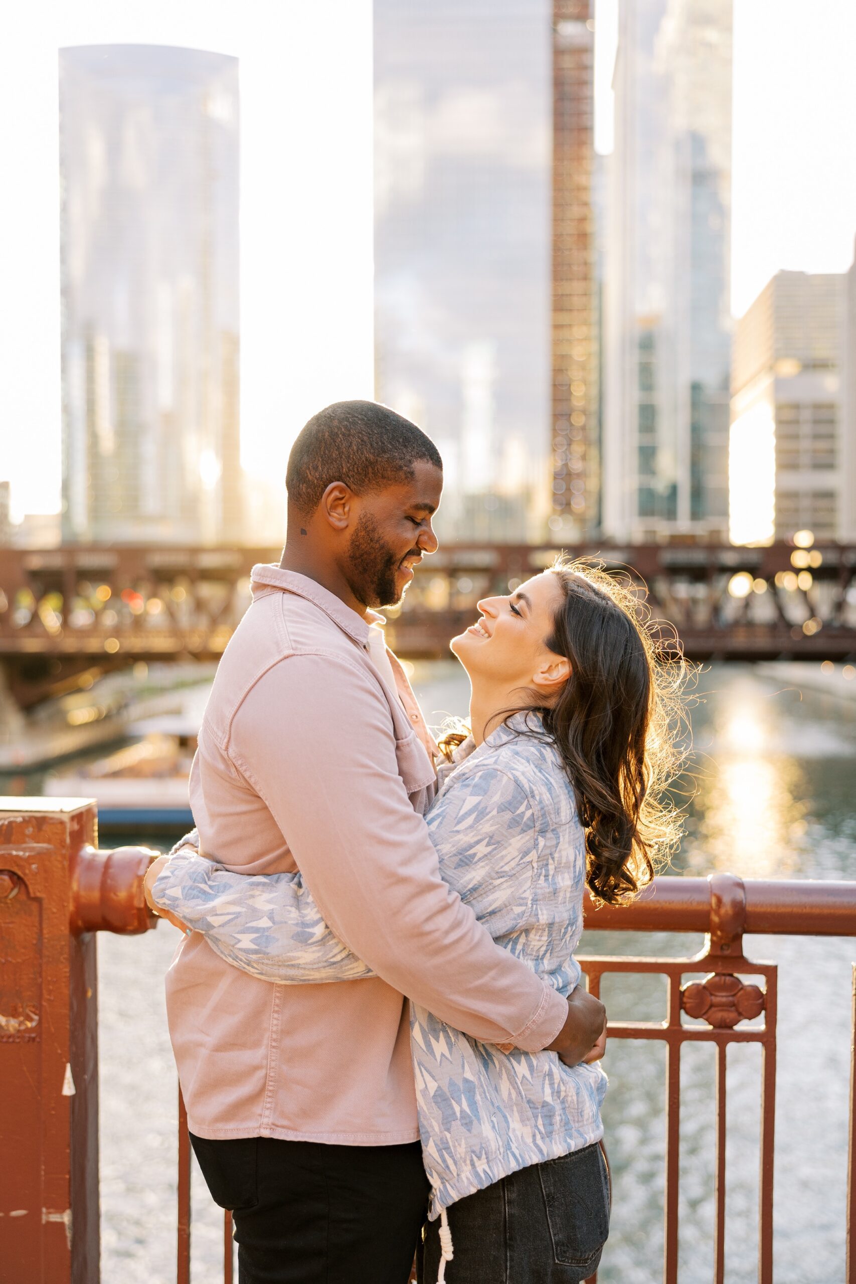 Couple smiles at each other during sunset Downtown Chicago engagement session