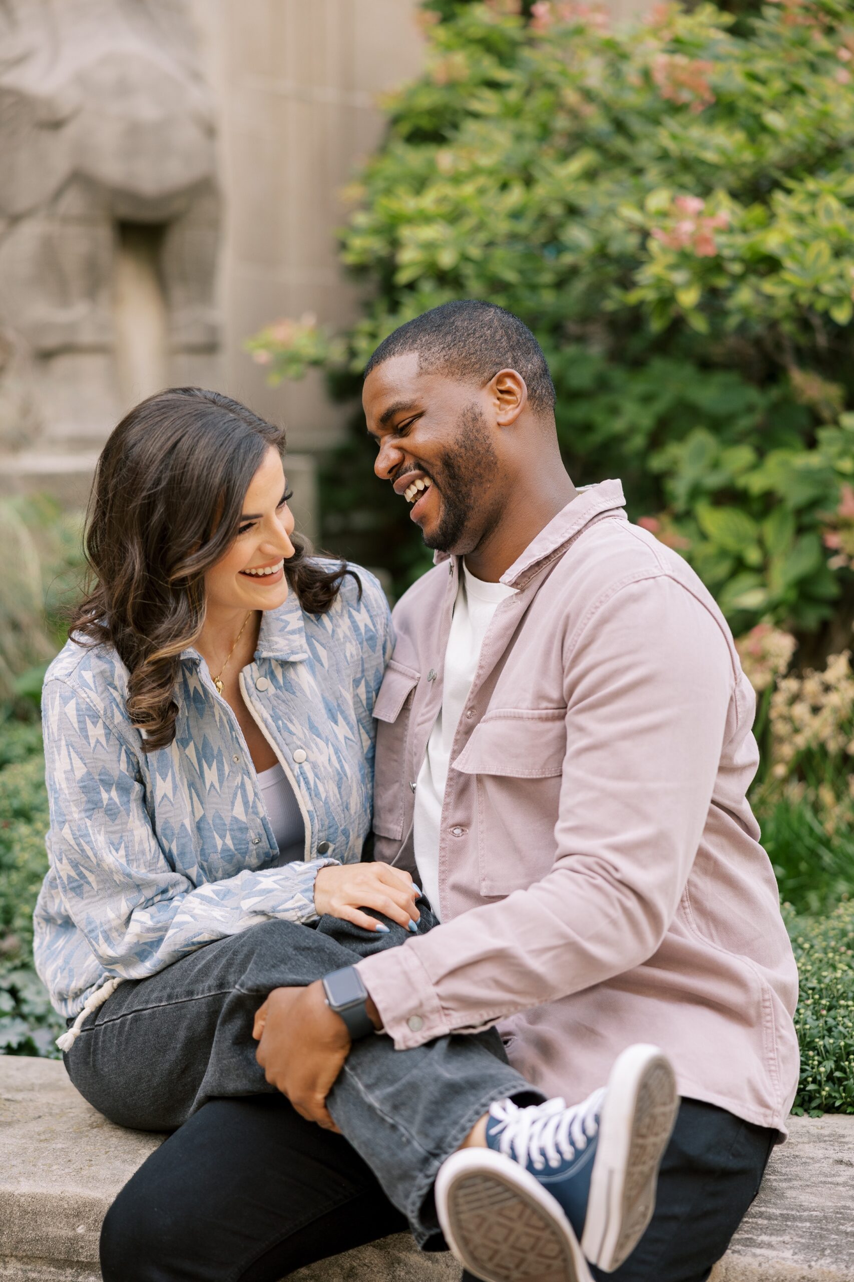 Man and woman laugh during Chicago engagement session