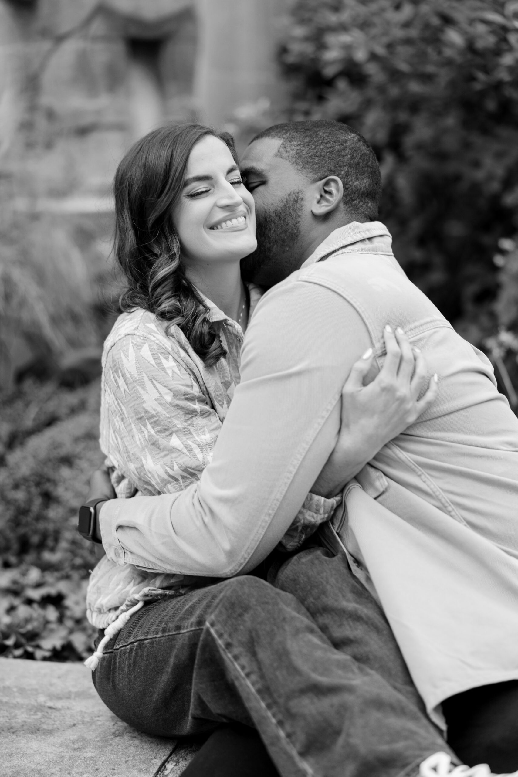 Man kisses woman playfully during chicago engagement photos