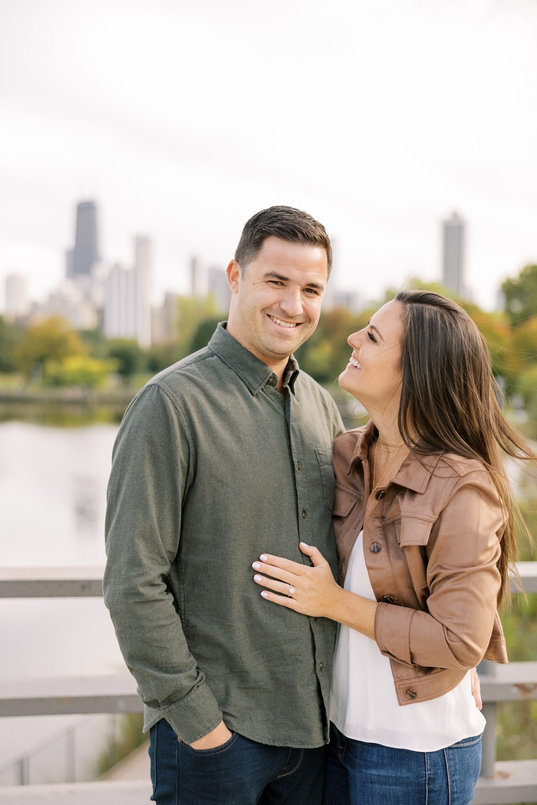 Woman smiles at man with the Chicago skyline behind them