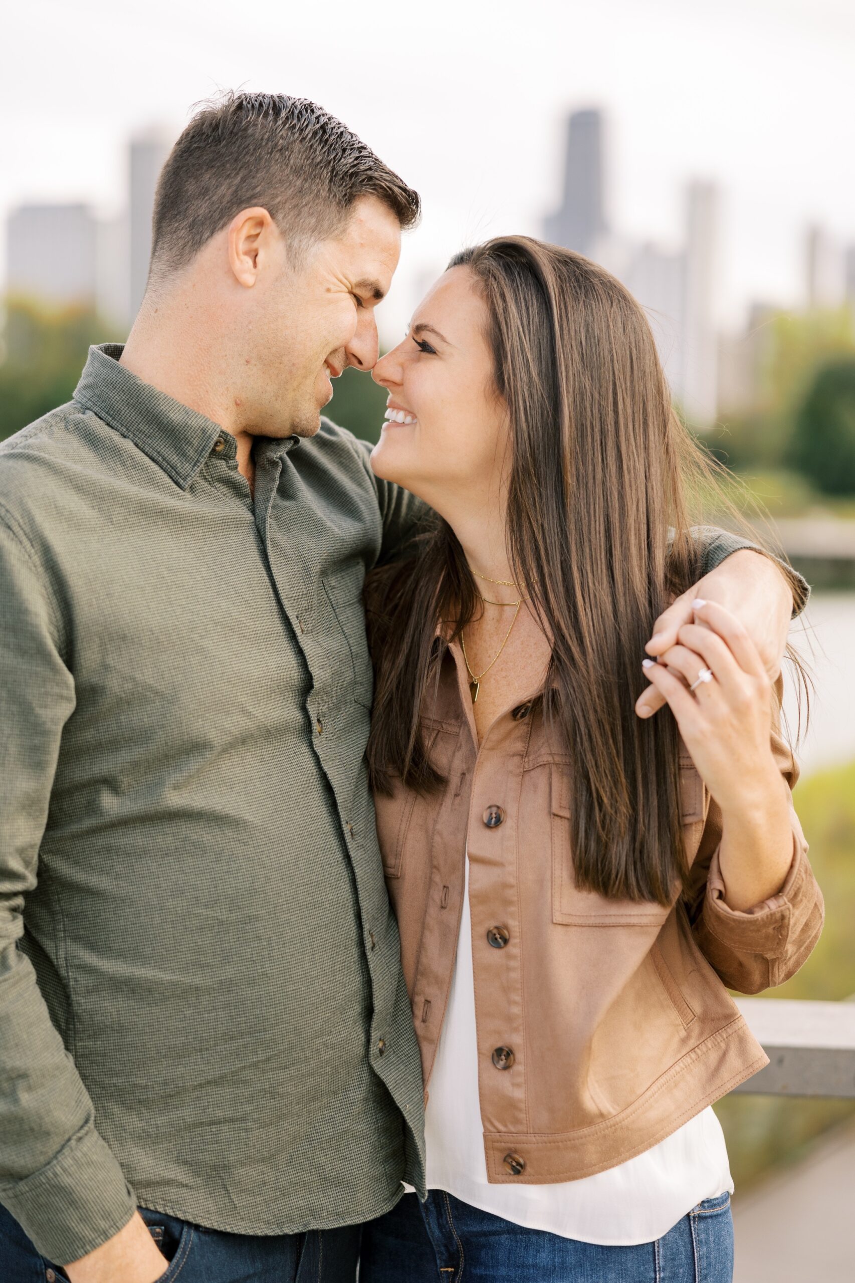 Man and woman smile at each other during Chicago engagement session