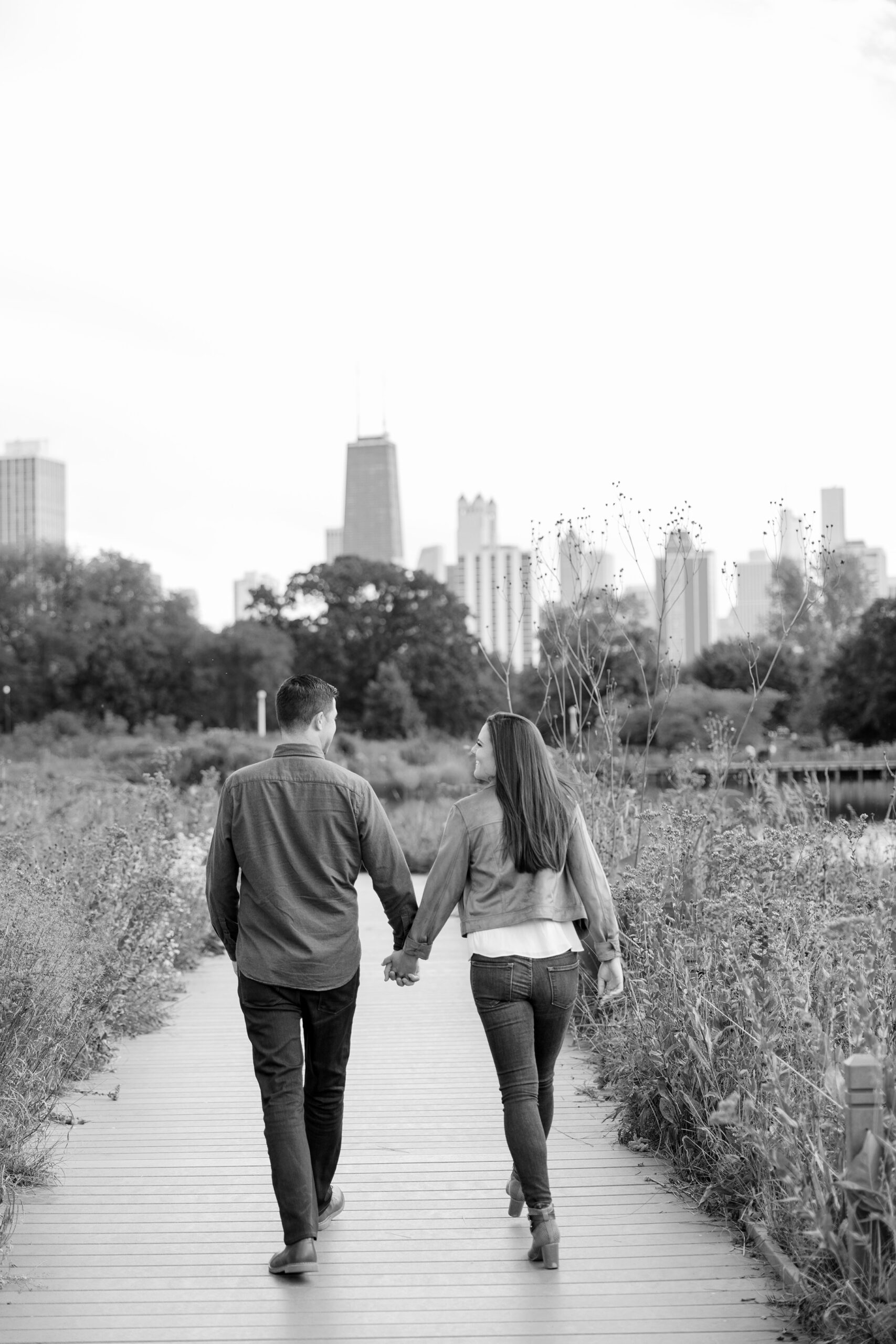 Man and woman walk during fall Lincoln Park Zoo engagement session